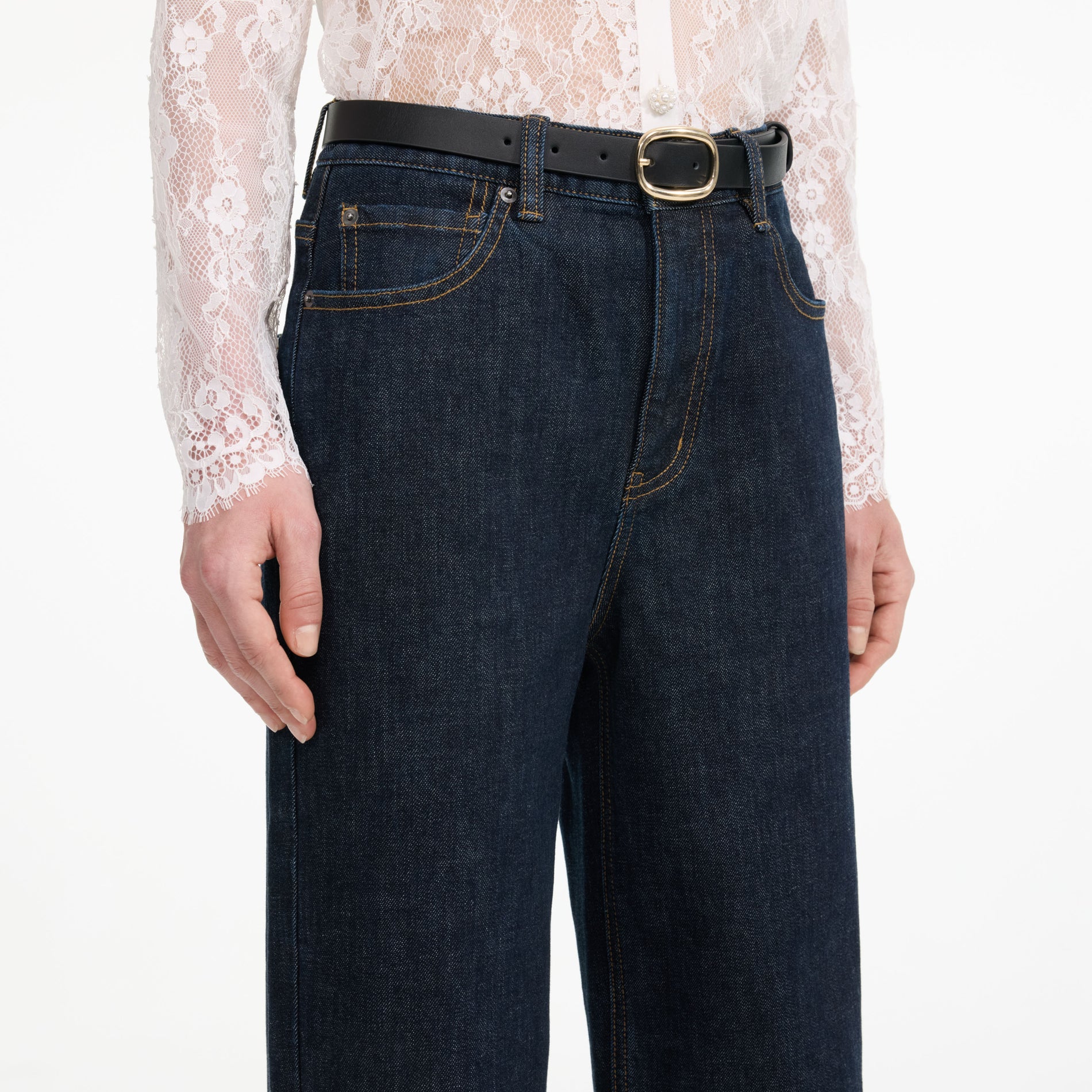 A close up of a woman wearing the Indigo Straight Leg Jeans