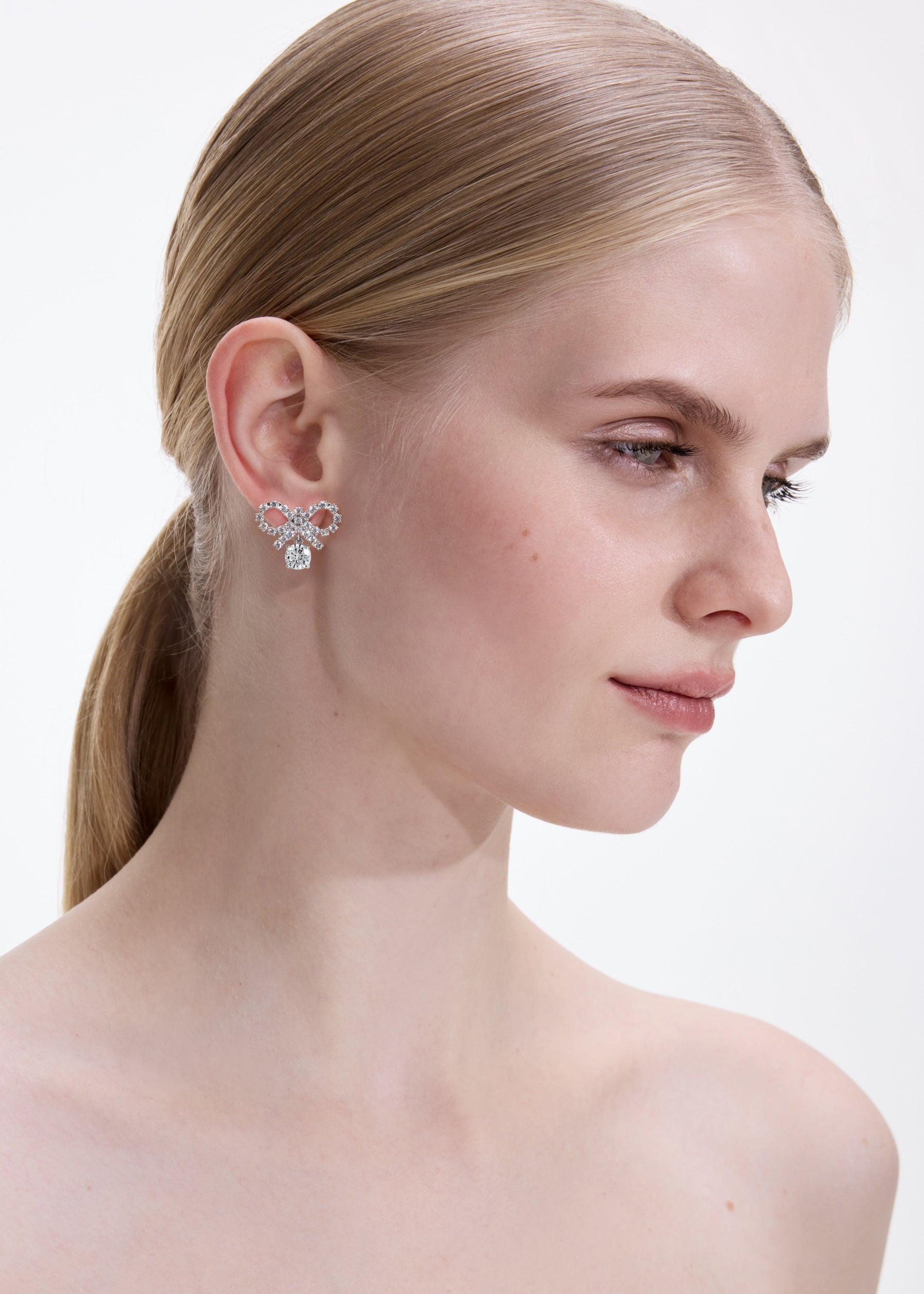 A photo of the Micro Bow Crystal Earrings