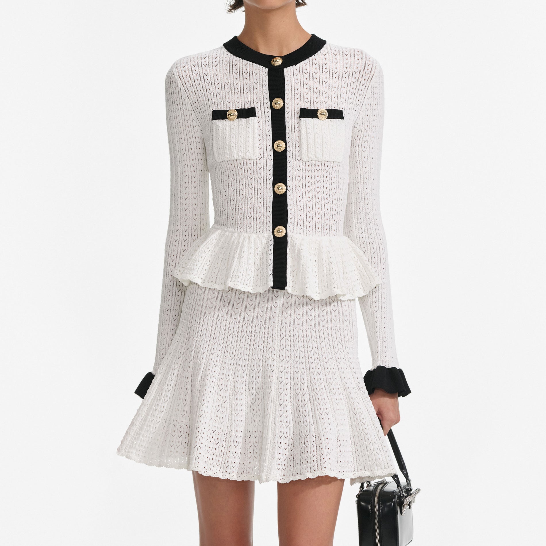 A close up of a woman wearing the White Pointelle Knit Contrast Mini Dress
