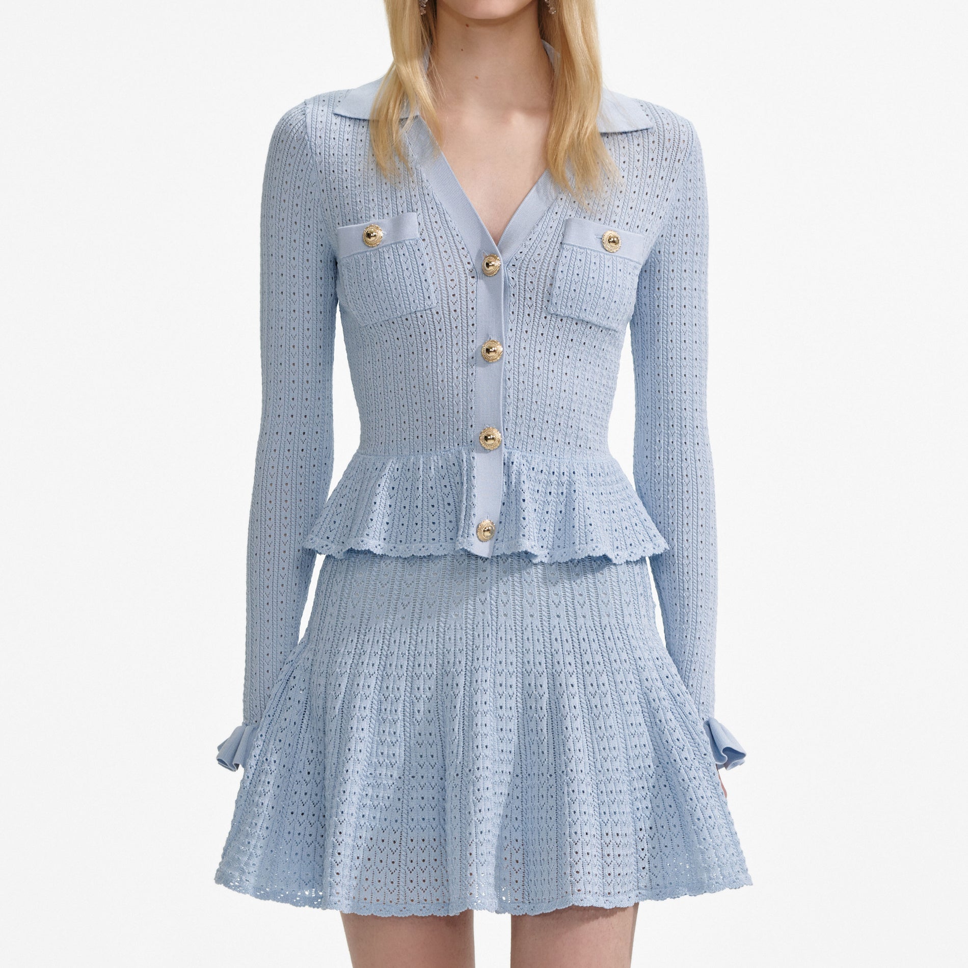 A close up of a woman wearing the Blue Pointelle Knit Mini Dress