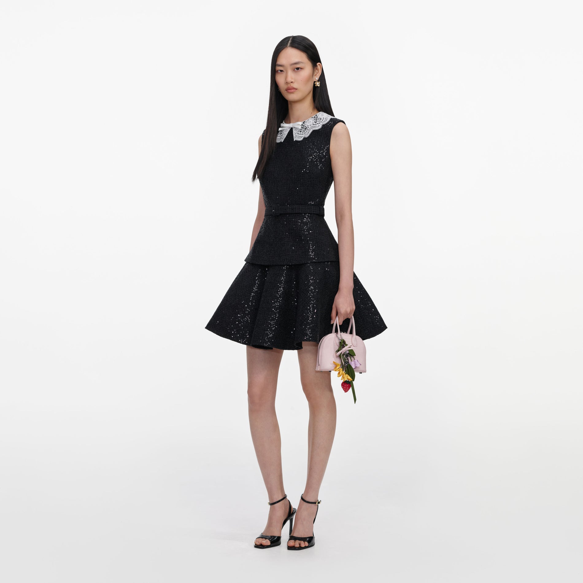 Side view of a woman wearing the Black Sequin Boucle Mini Dress