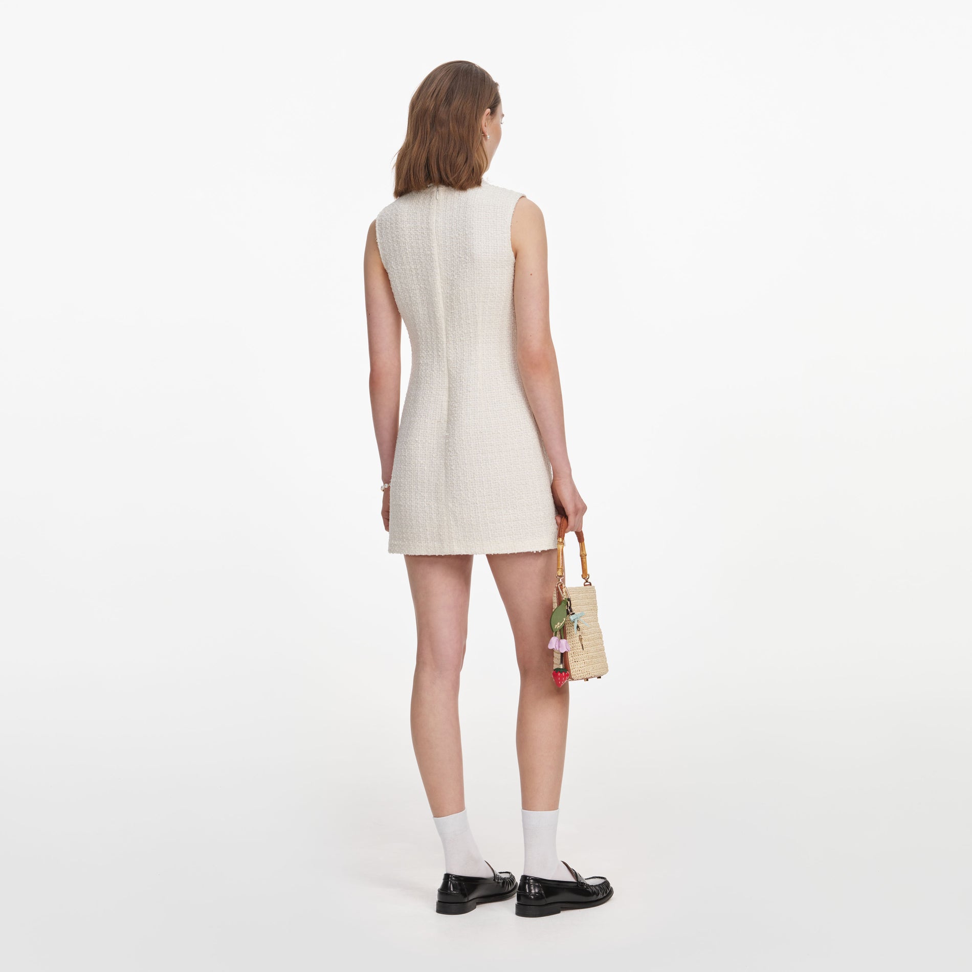 Back view of a woman wearing the Cream Sleeveless Boucle Mini Dress