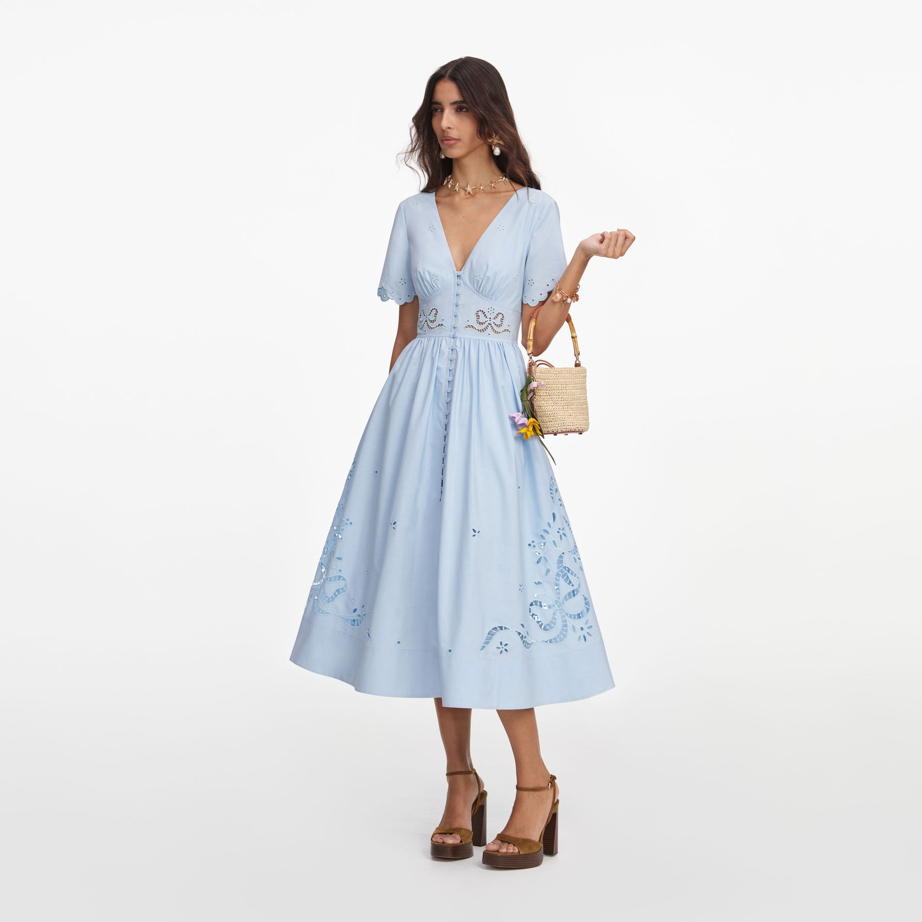 Side view of a woman wearing the Blue Cotton Embroidered Midi Dress
