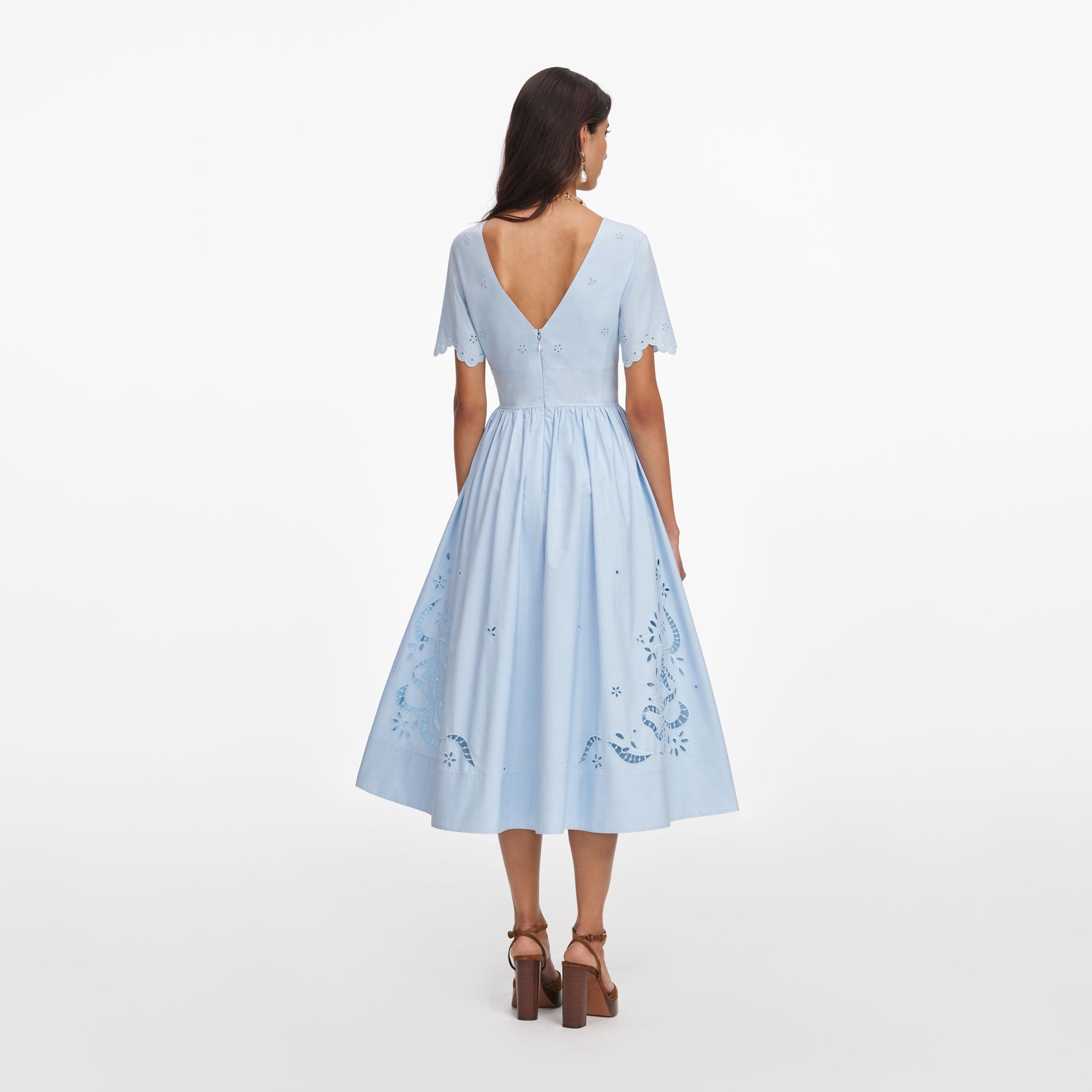 Back view of a woman wearing the Blue Cotton Embroidered Midi Dress