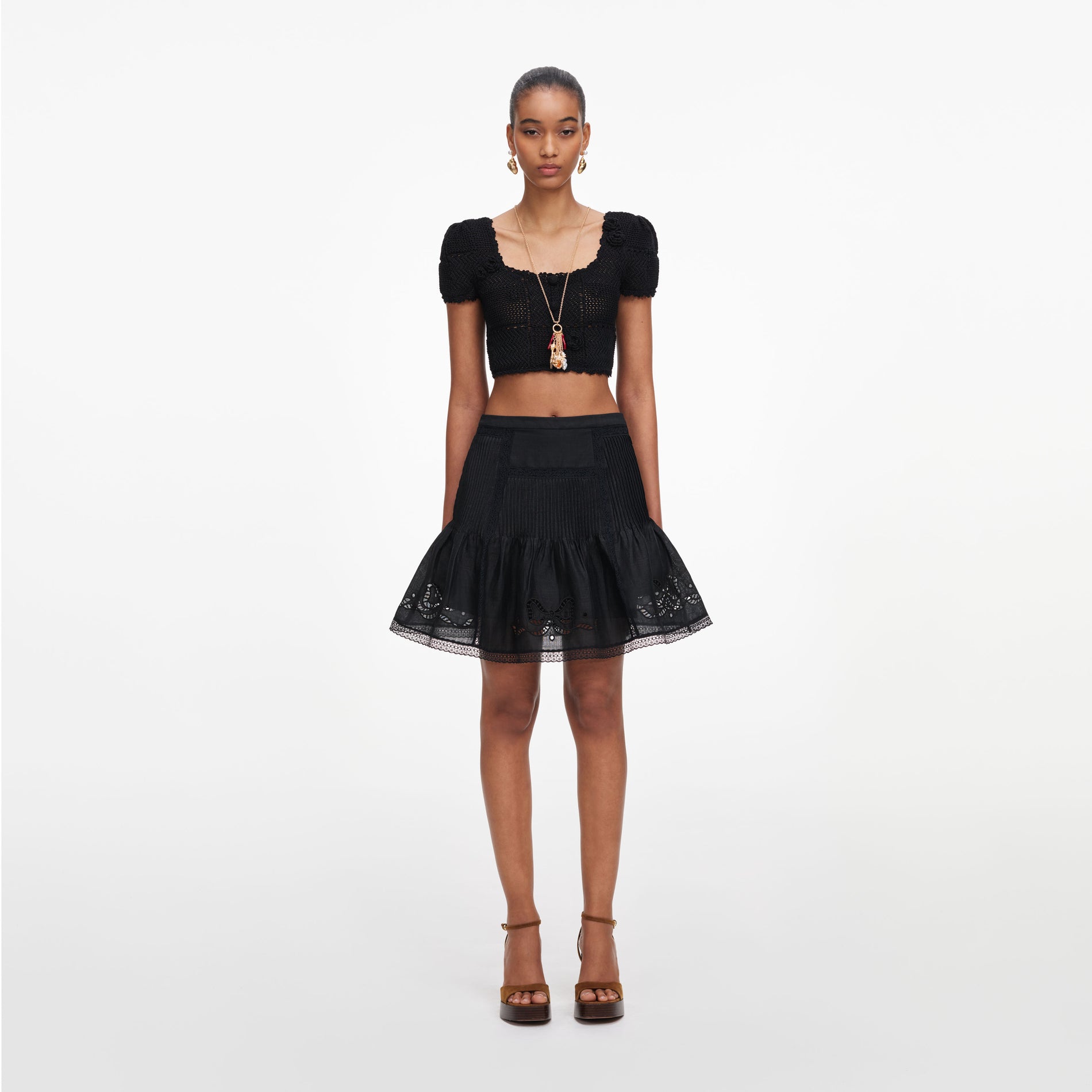 Front view of a woman wearing the Black Embroidered Mini Skirt