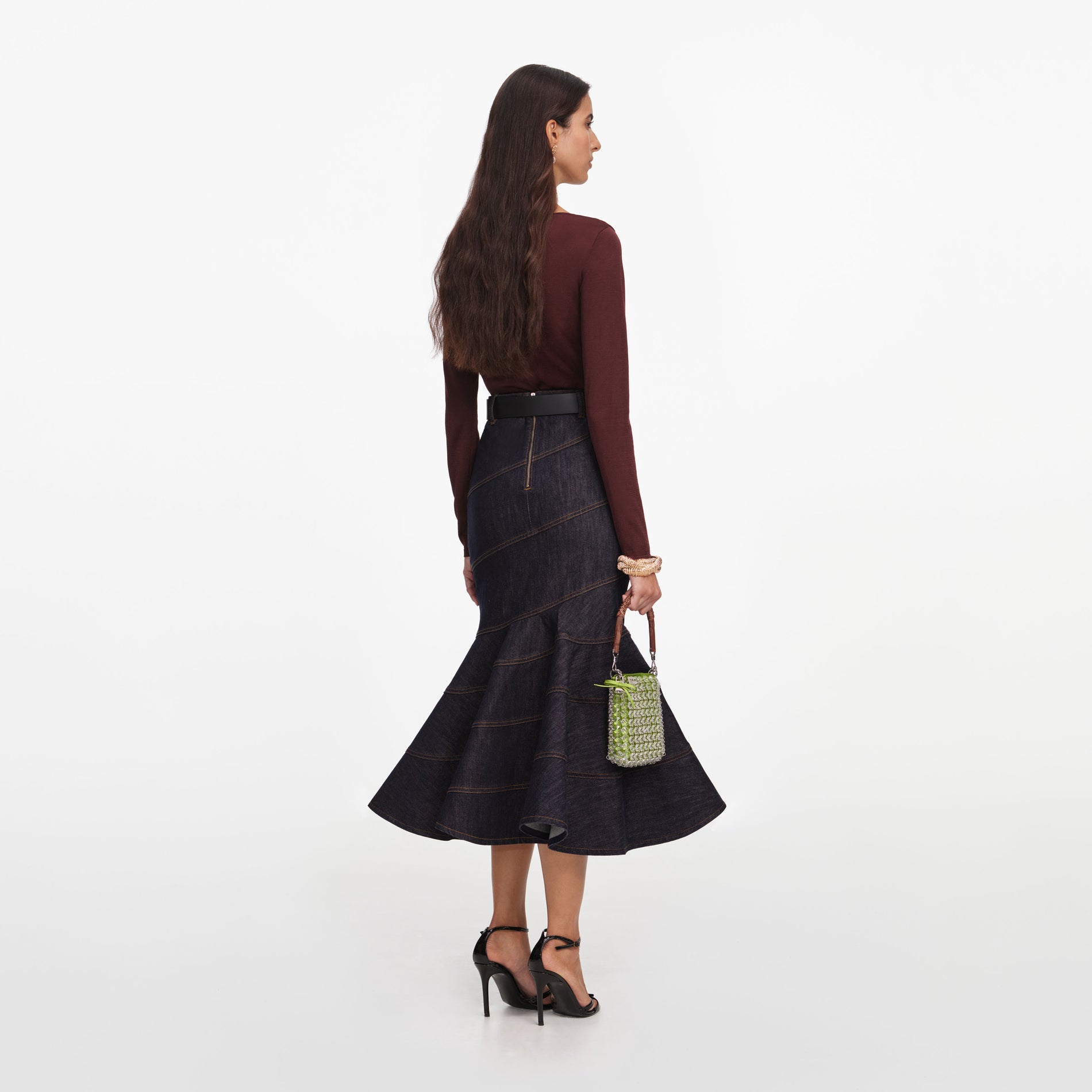 Back view of a woman wearing the Indigo Denim Belted Midi Skirt