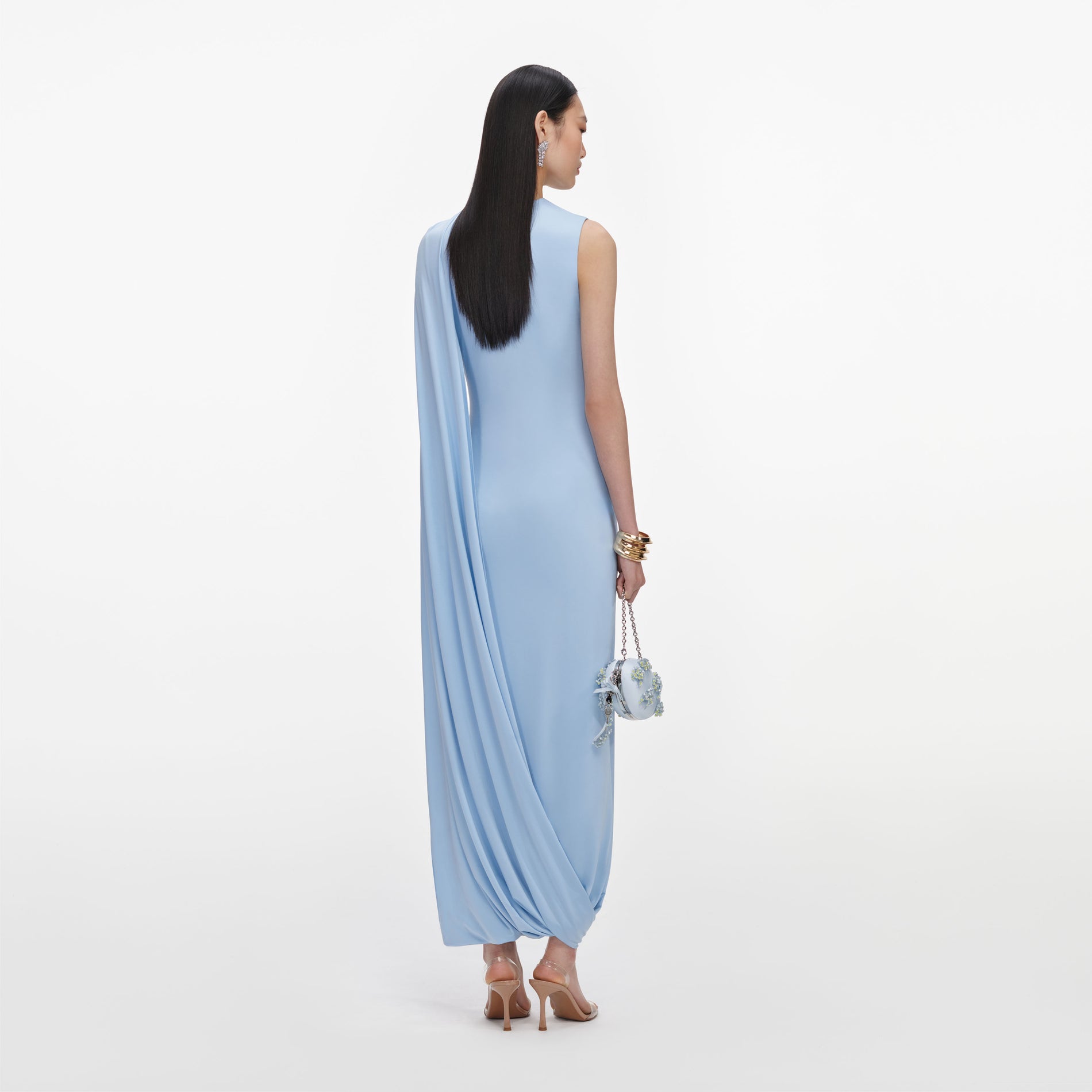 Back view of a woman wearing the Blue Jersey Draped Maxi Dress