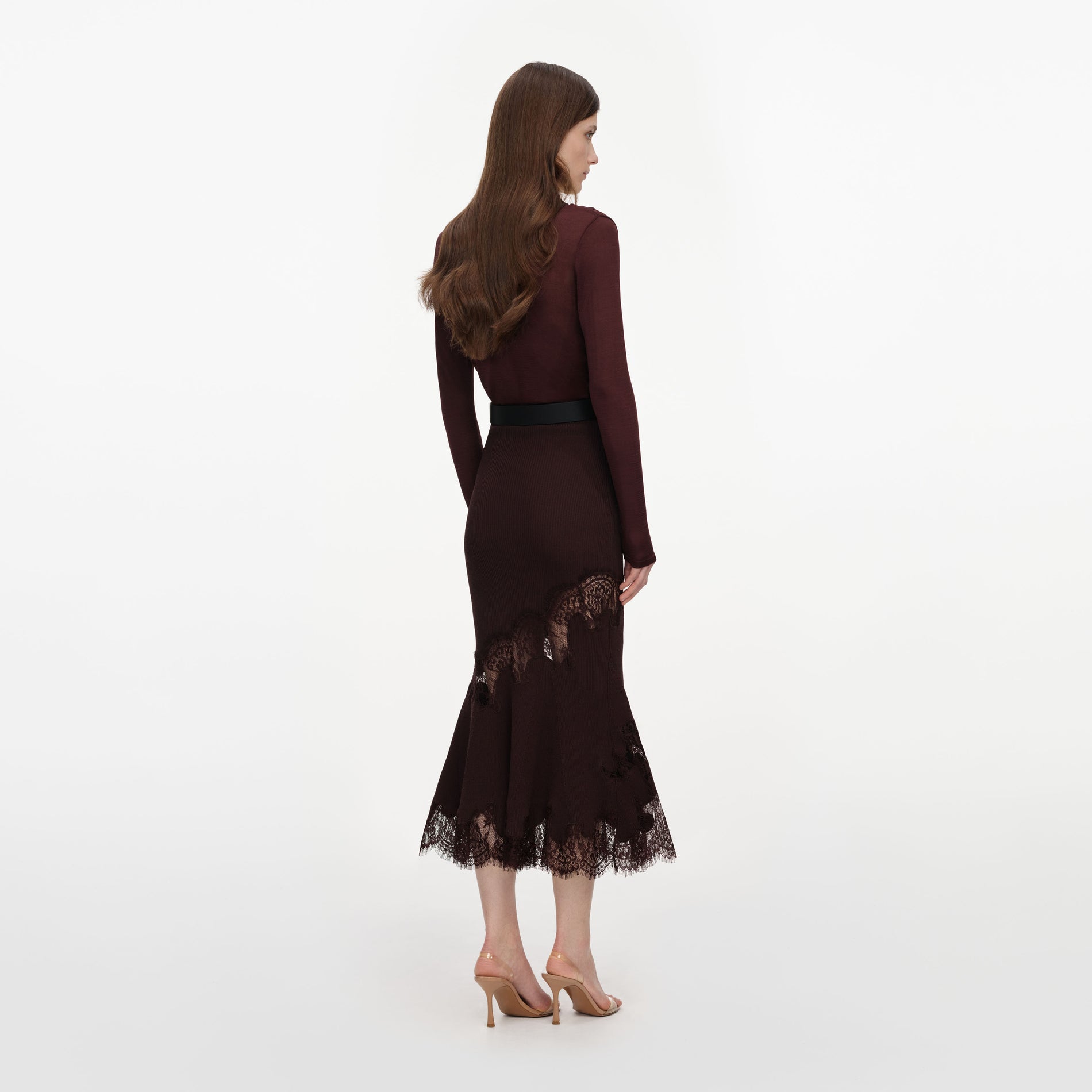 Back view of a woman wearing the Brown Ribbed Knit Midi Skirt