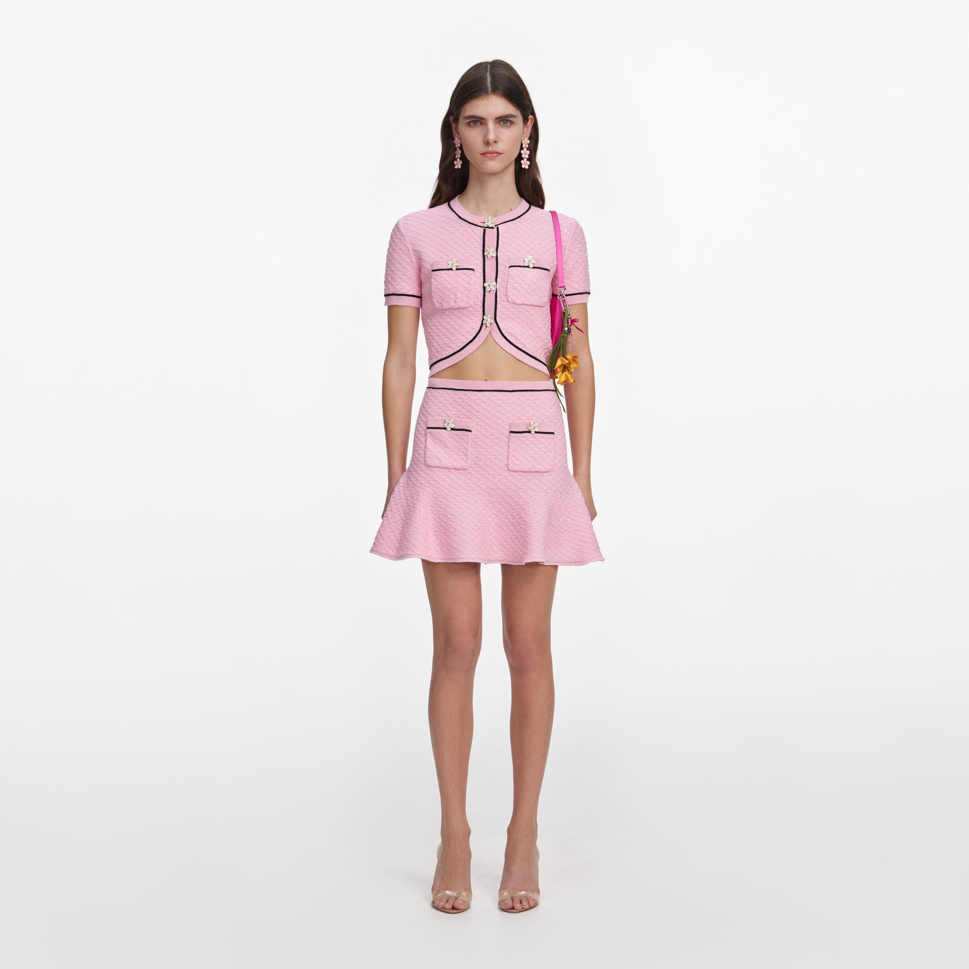 Front view of a woman wearing the Pink Flower Knit Mini Skirt