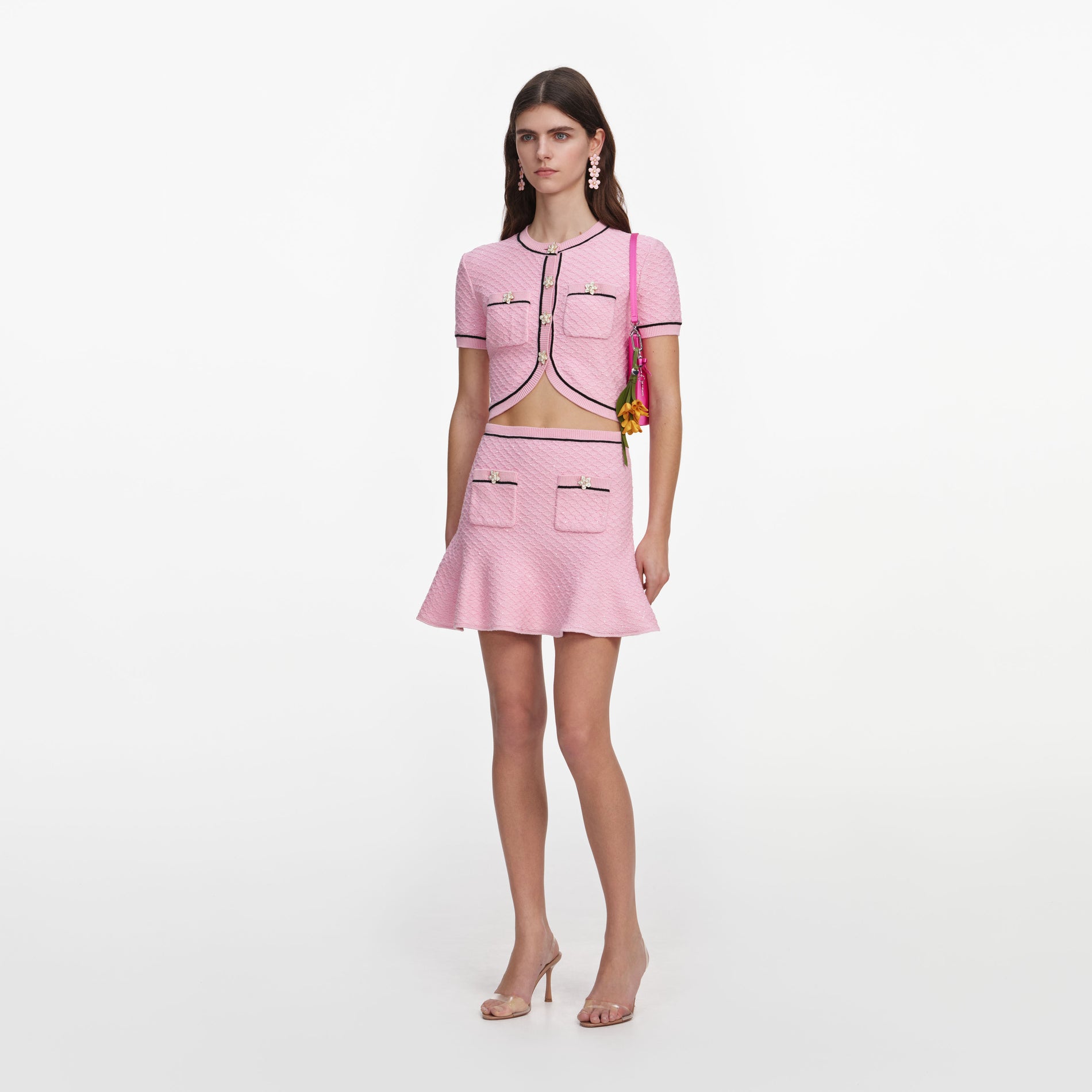 Side view of a woman wearing the Pink Flower Knit Mini Skirt