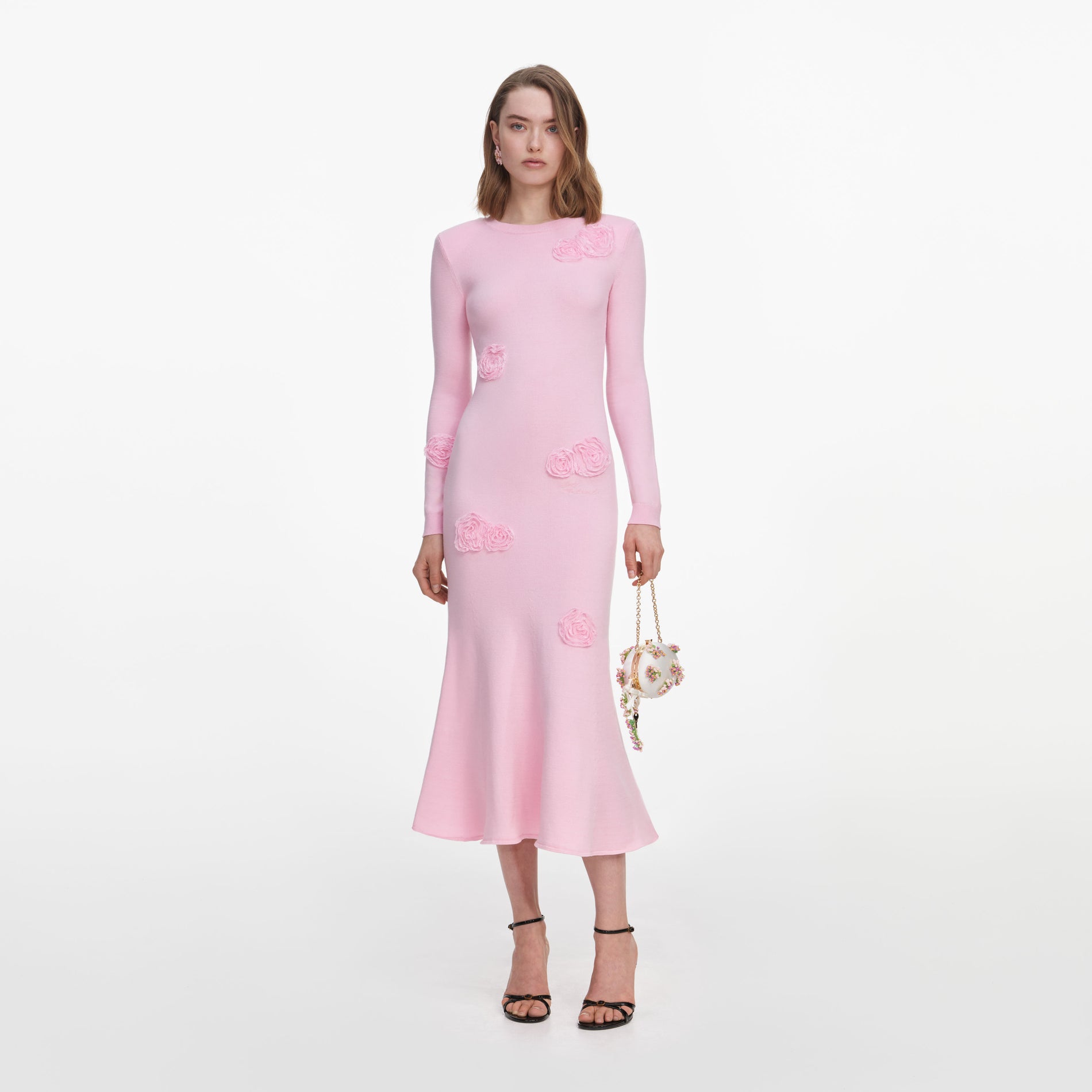 Front view of a woman wearing the Pink Flower Knit Midi Dress