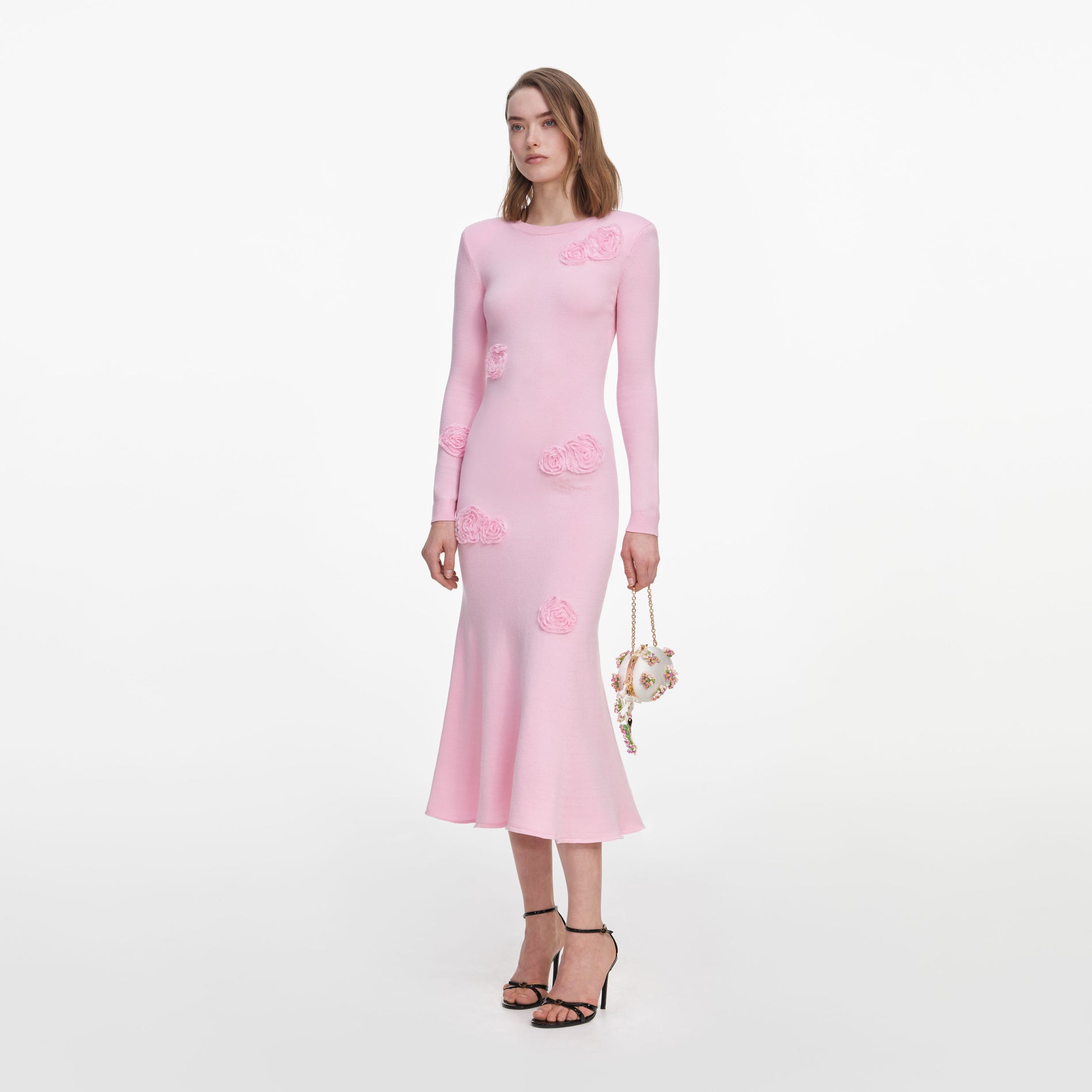 Side view of a woman wearing the Pink Flower Knit Midi Dress