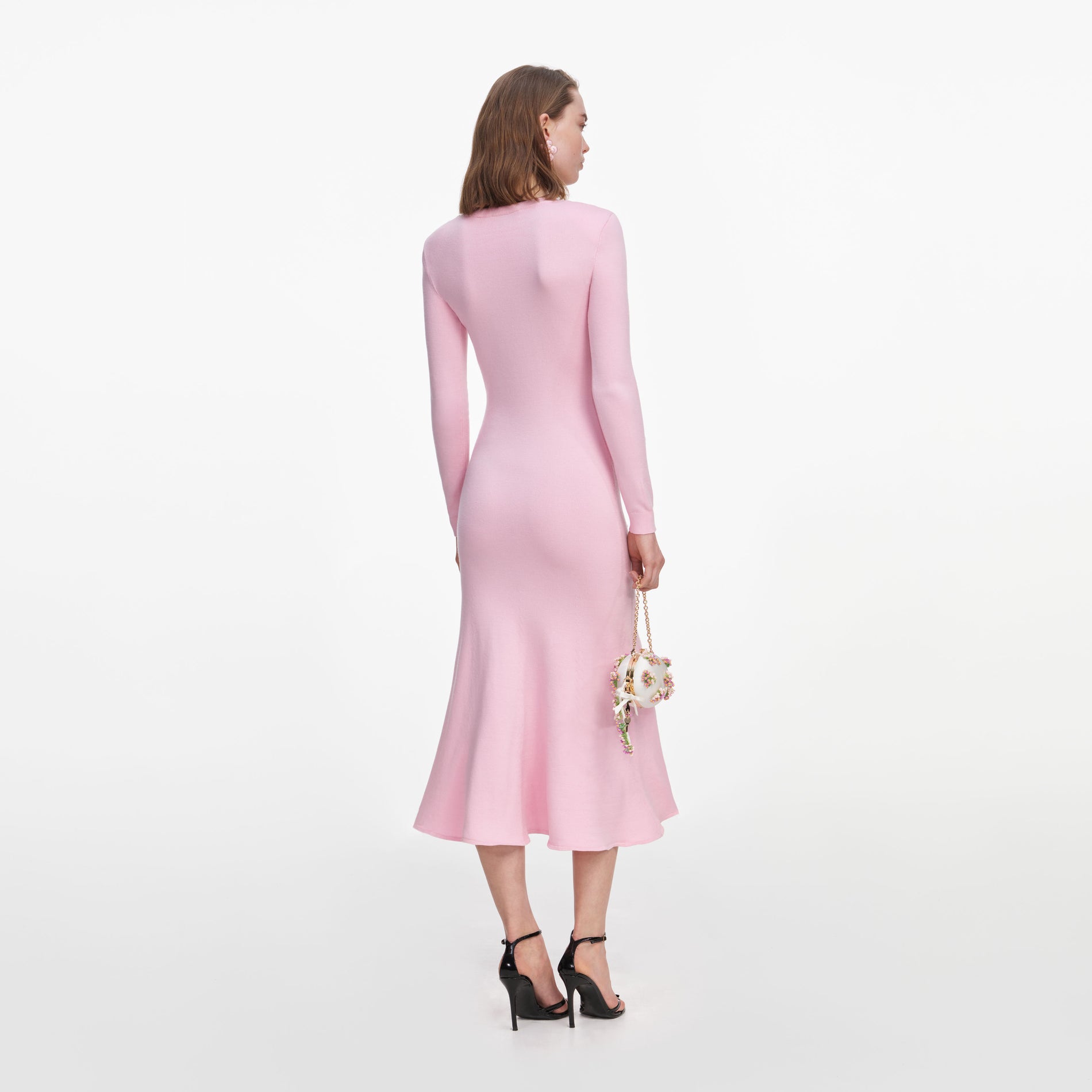 Back view of a woman wearing the Pink Flower Knit Midi Dress