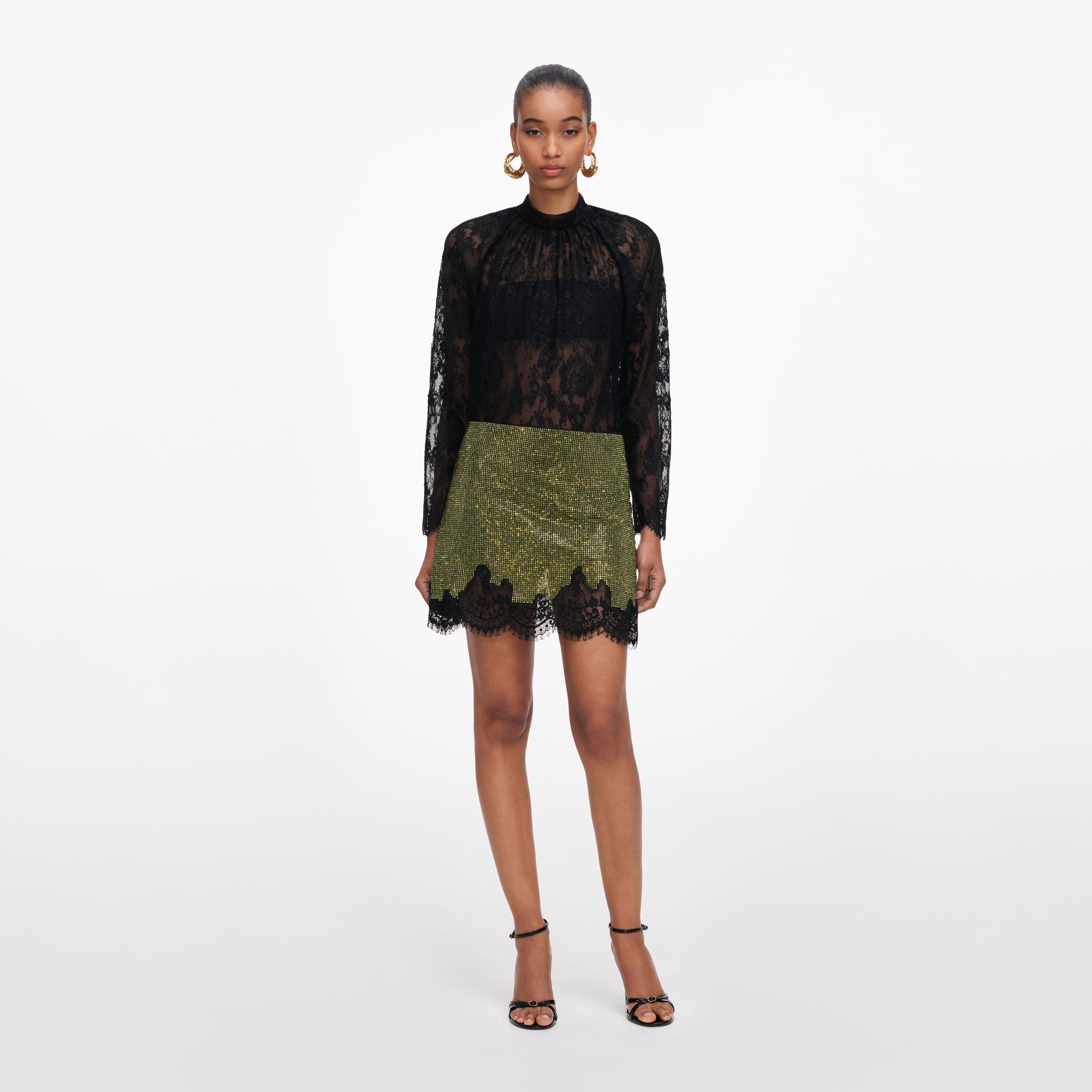 Front view of a woman wearing the Green Crystal Chainmail Mini Skirt