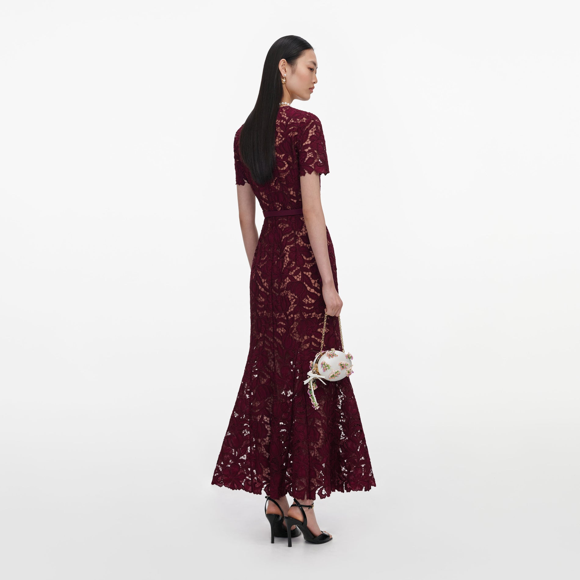 Back view of a woman wearing the Burgundy Lace Midi Dress
