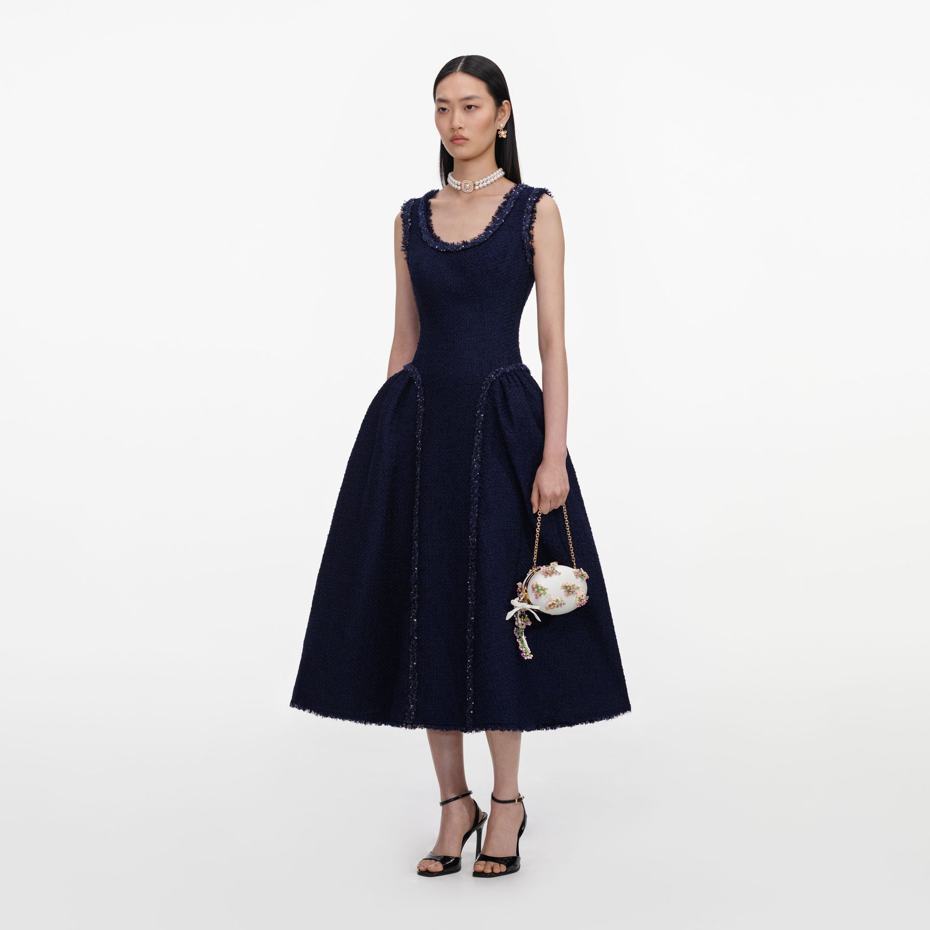 Side view of a woman wearing the Navy Boucle Midi Dress