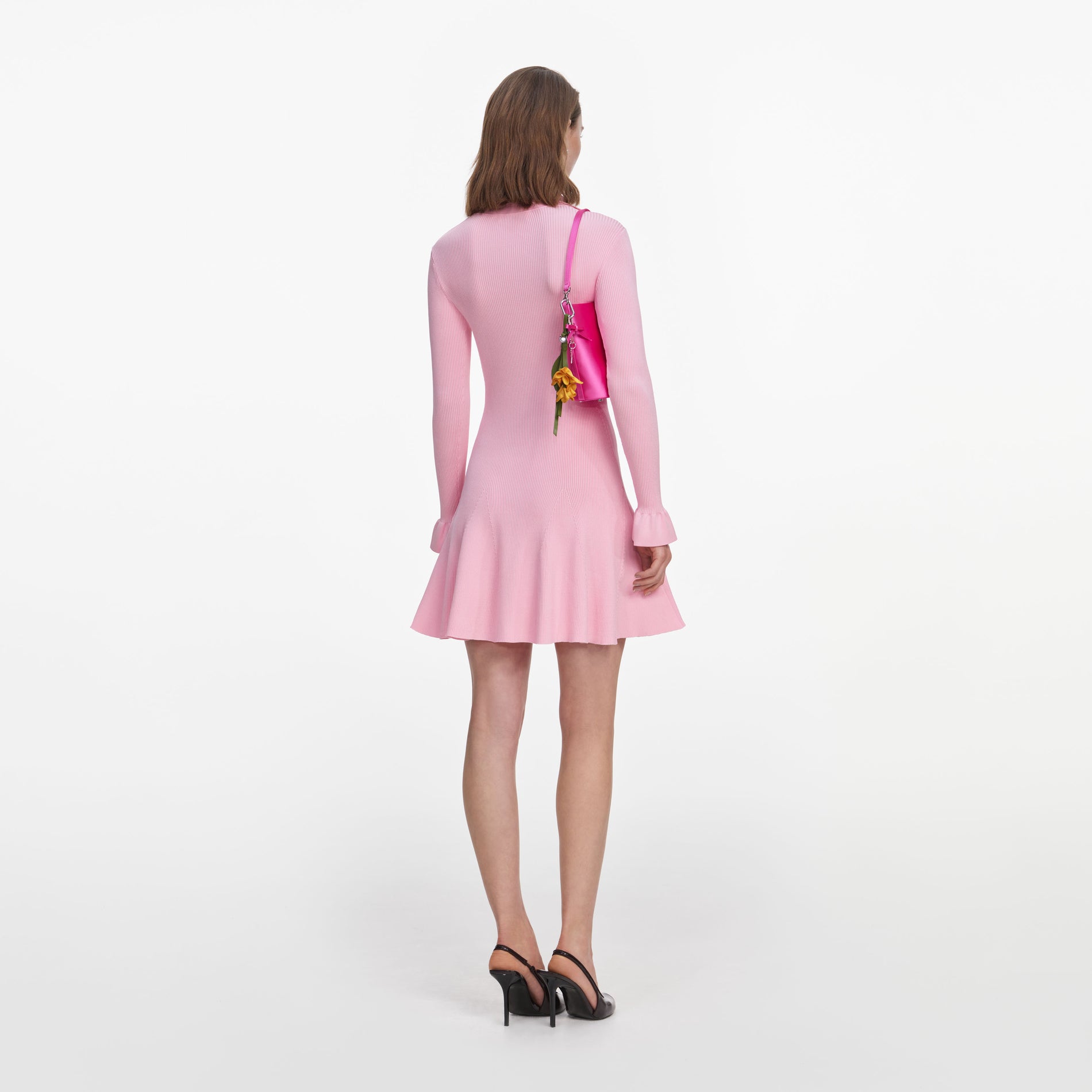 Back view of a woman wearing the Pink Viscose Knit Tie Mini Dress