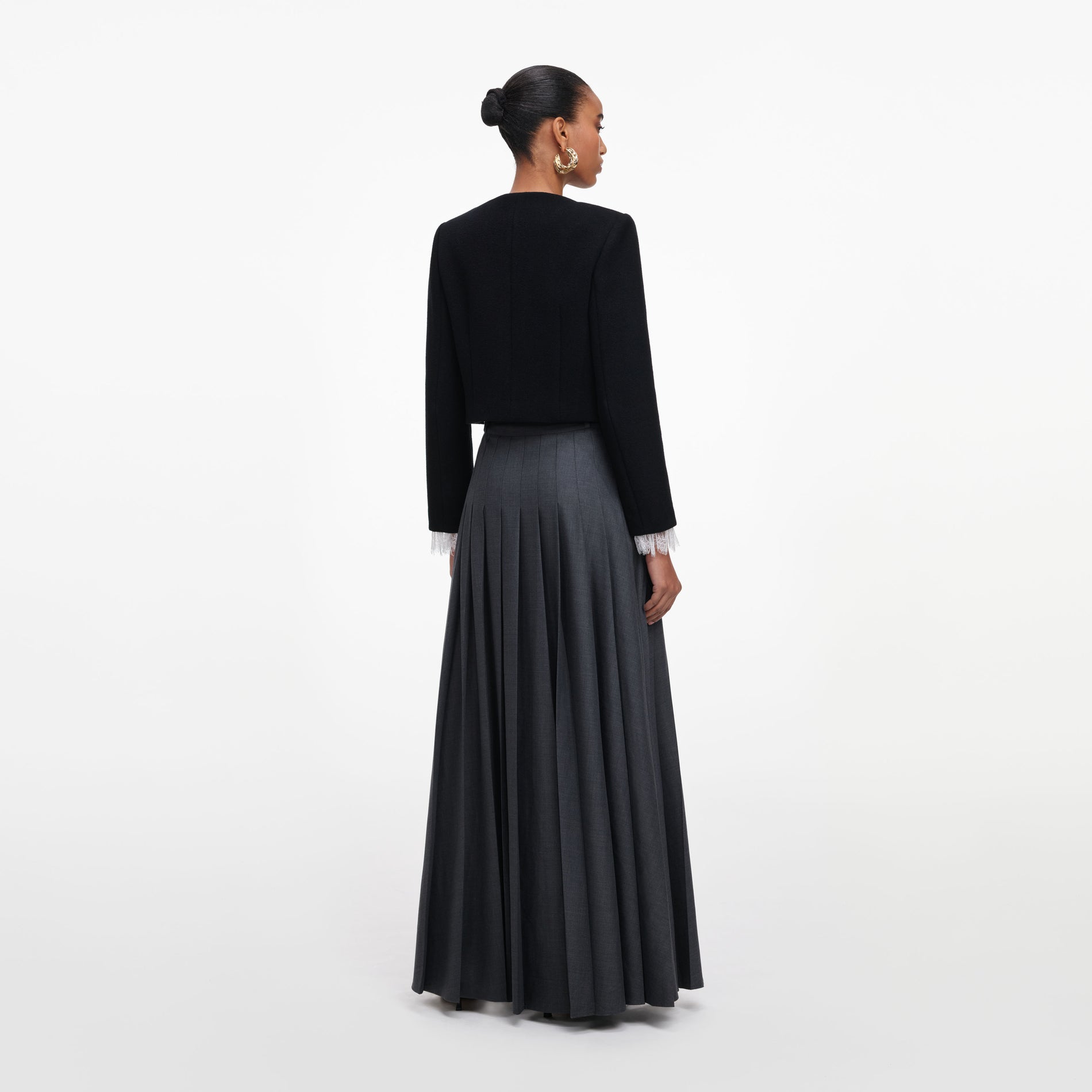 Back view of a woman wearing the Grey Pleated Maxi Skirt