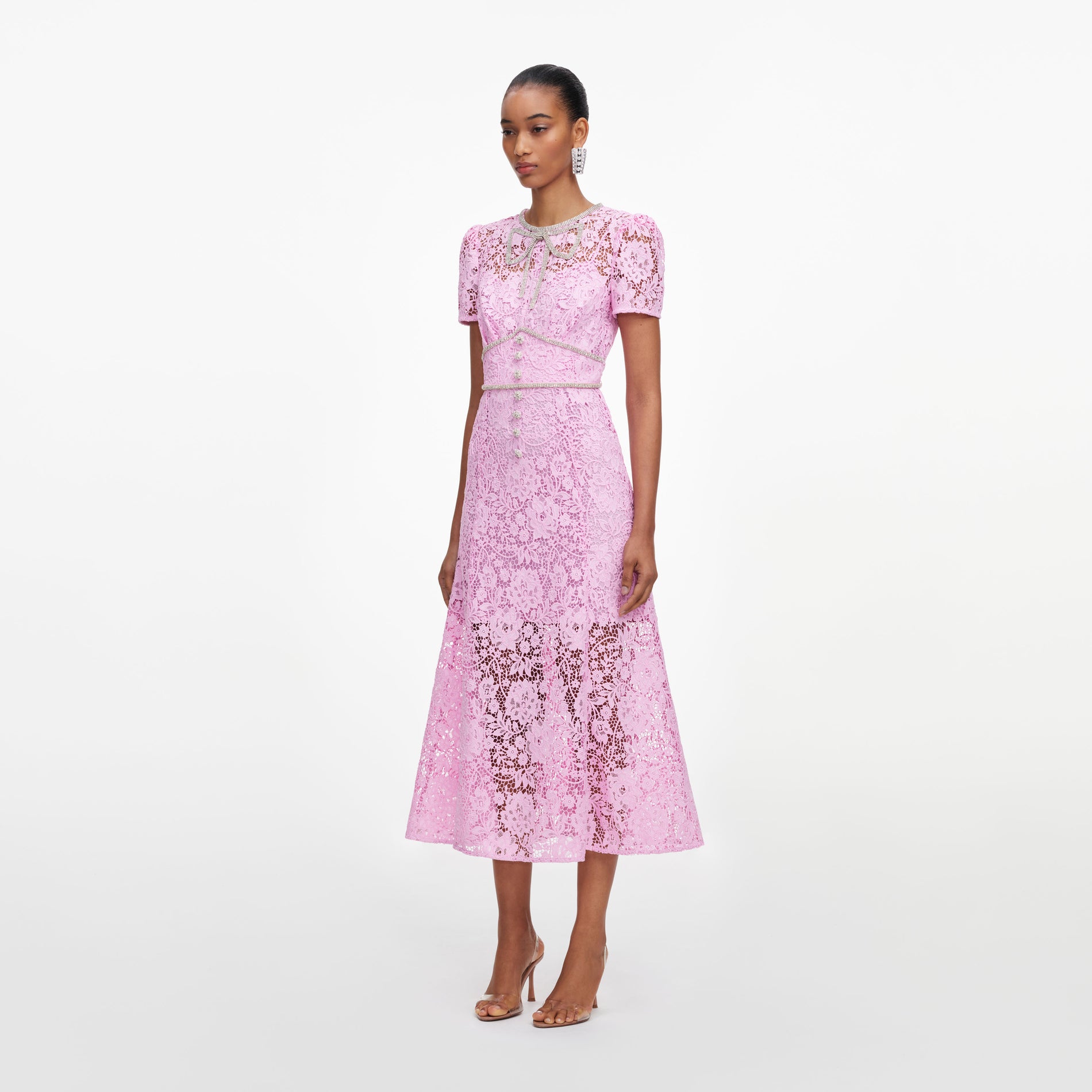 Side view of a woman wearing the Pink Cord Lace Midi Dress