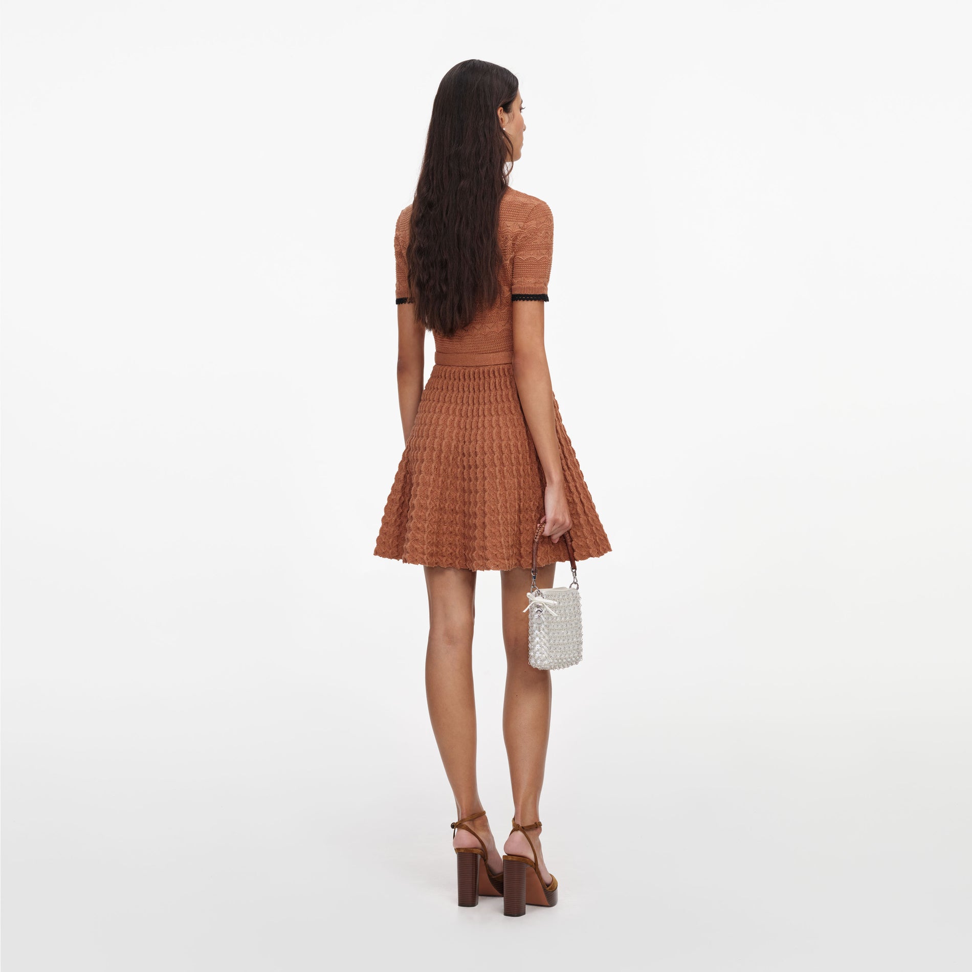 Back view of a woman wearing the Brown Pointelle Knit Mini Dress