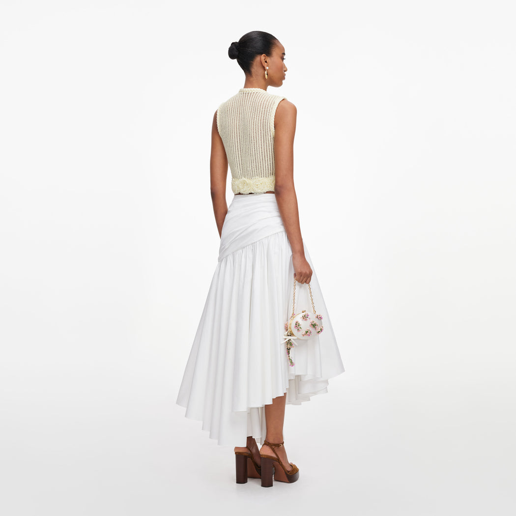 Back view of a woman wearing the Yellow Crochet Flower Knit Top