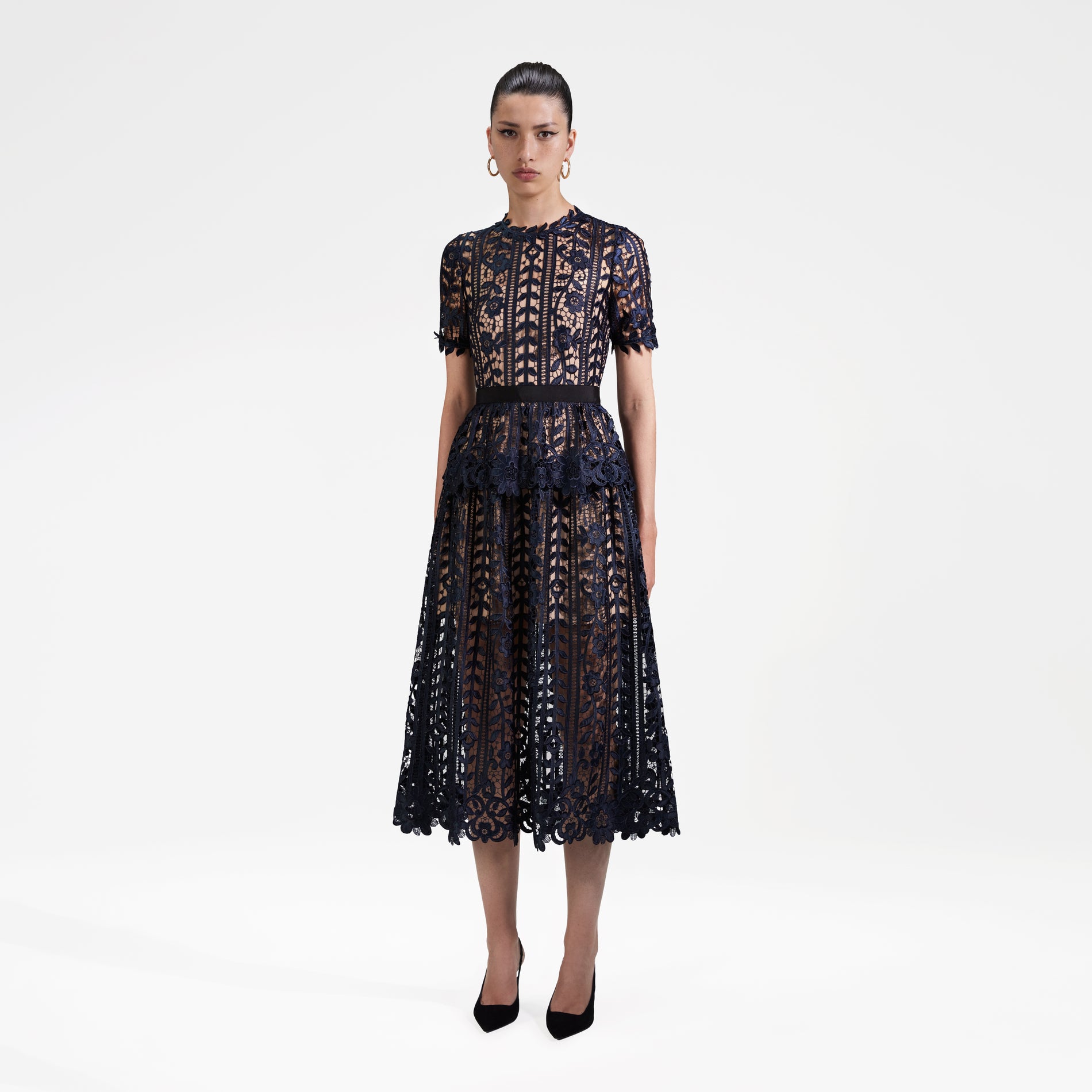 Side view of a woman wearing the Navy Lace Midi Dress