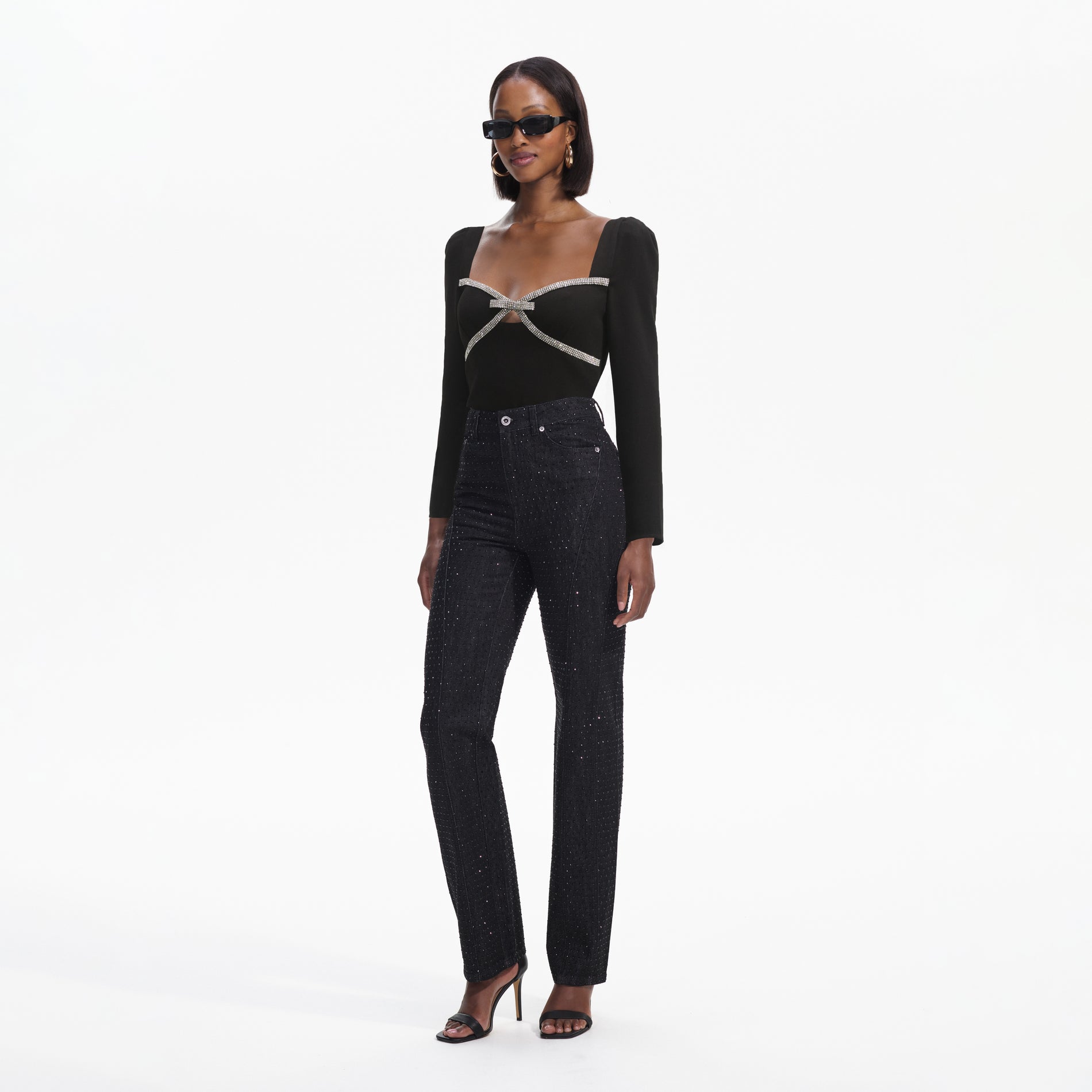 Side view of a woman wearing the Black Diamante Bow Top