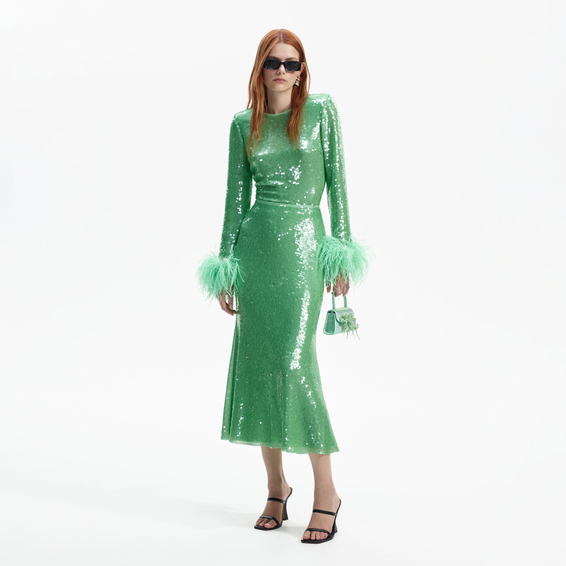 Side view of a woman wearing the Mint Sequin Midi Skirt