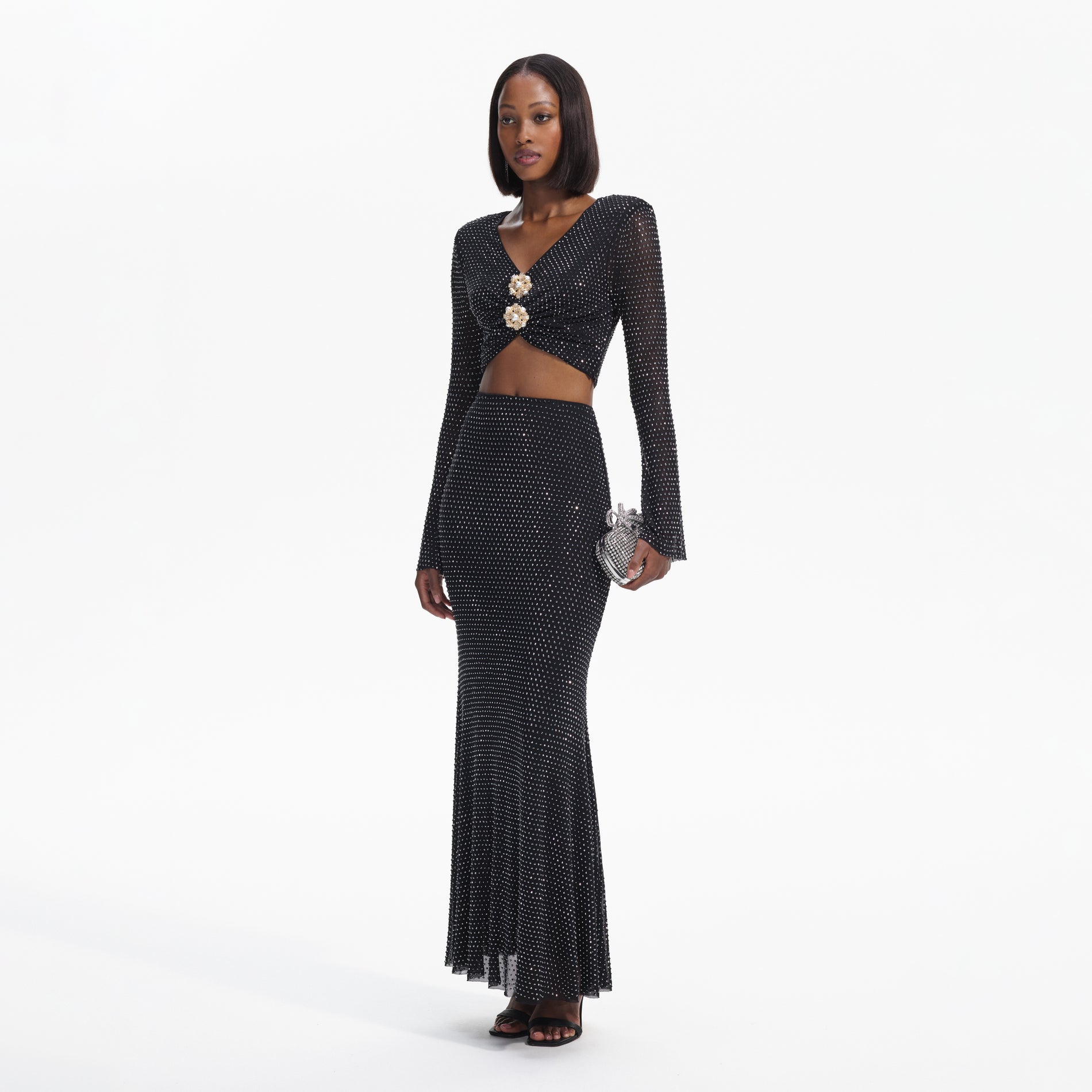 Side view of a woman wearing the Black Rhinestone  Maxi Skirt