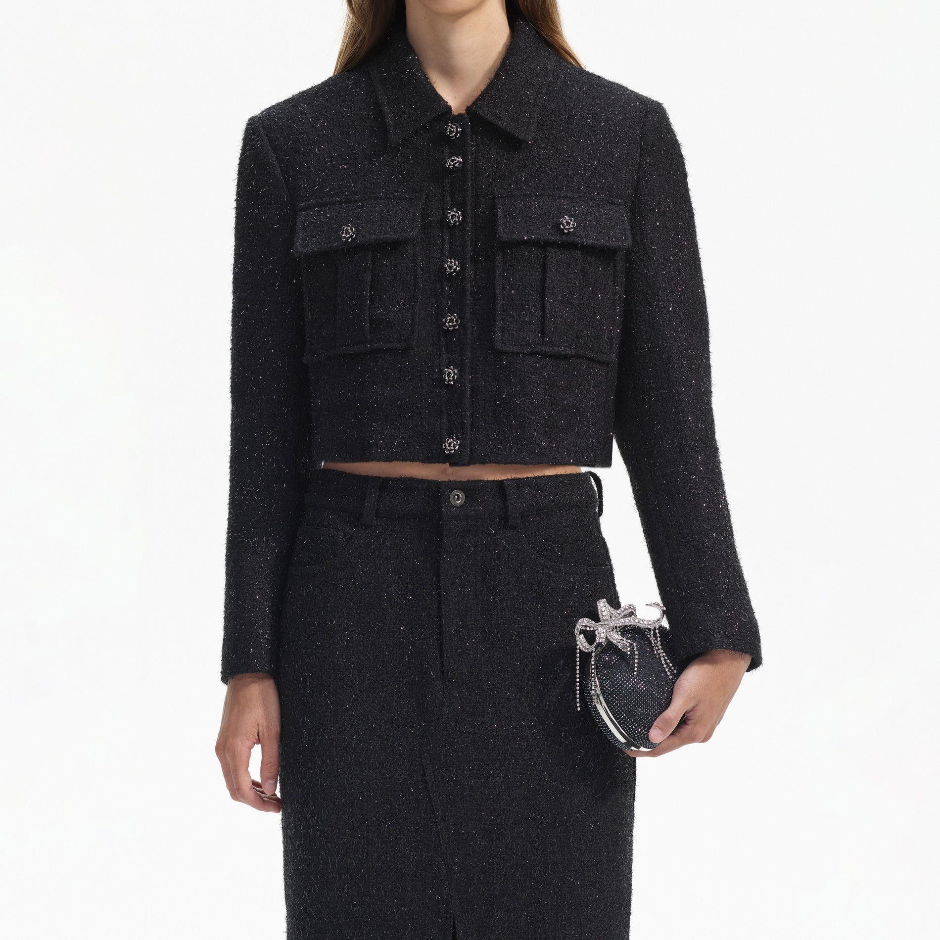 A close up of a woman wearing the Black Boucle Maxi Skirt