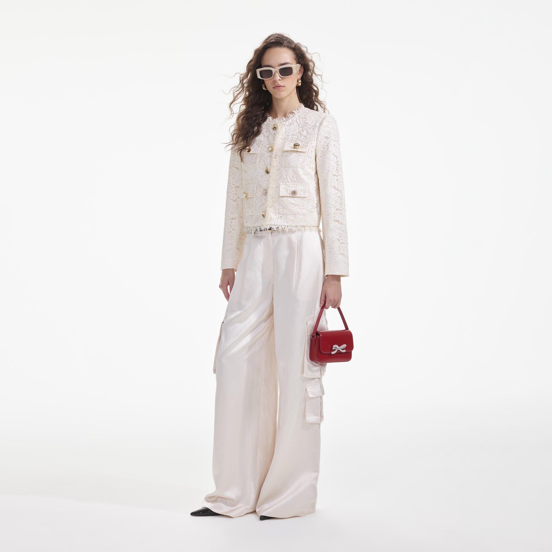 Side view of a woman wearing the Cream Cord Lace Jacket