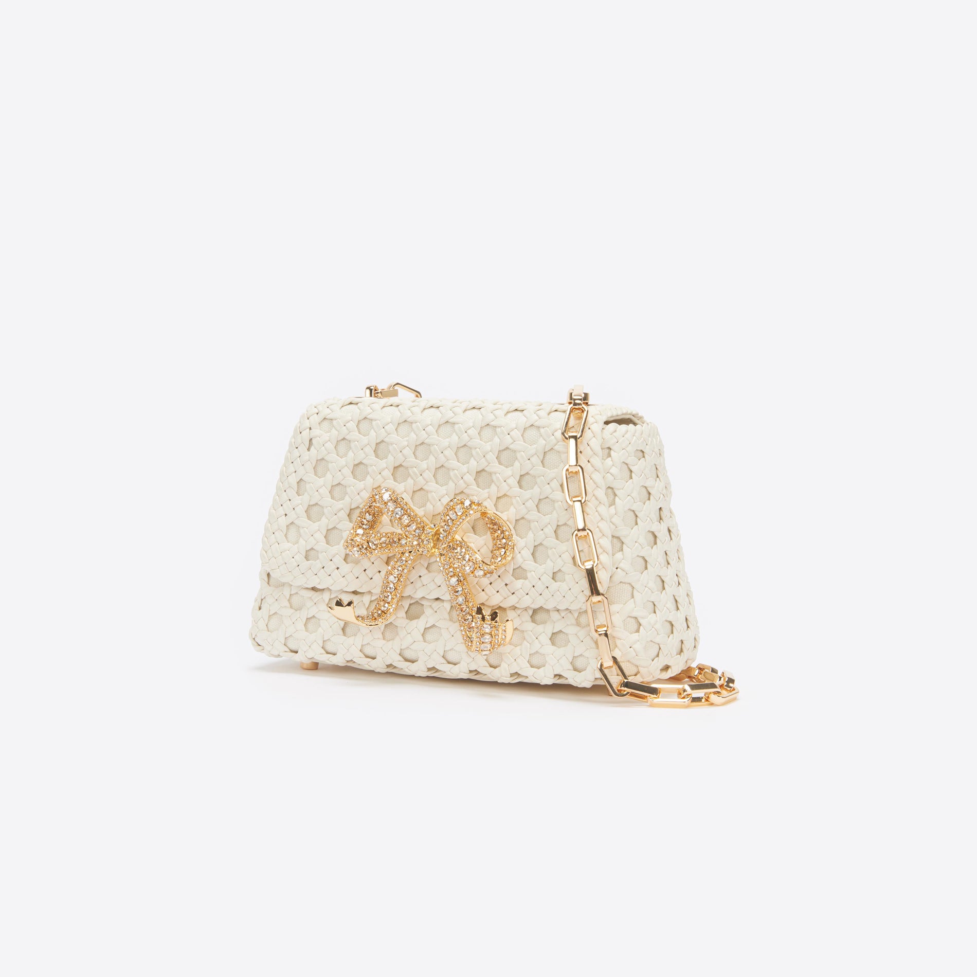 Side view of a woman wearing the Cream Woven Leather Bag