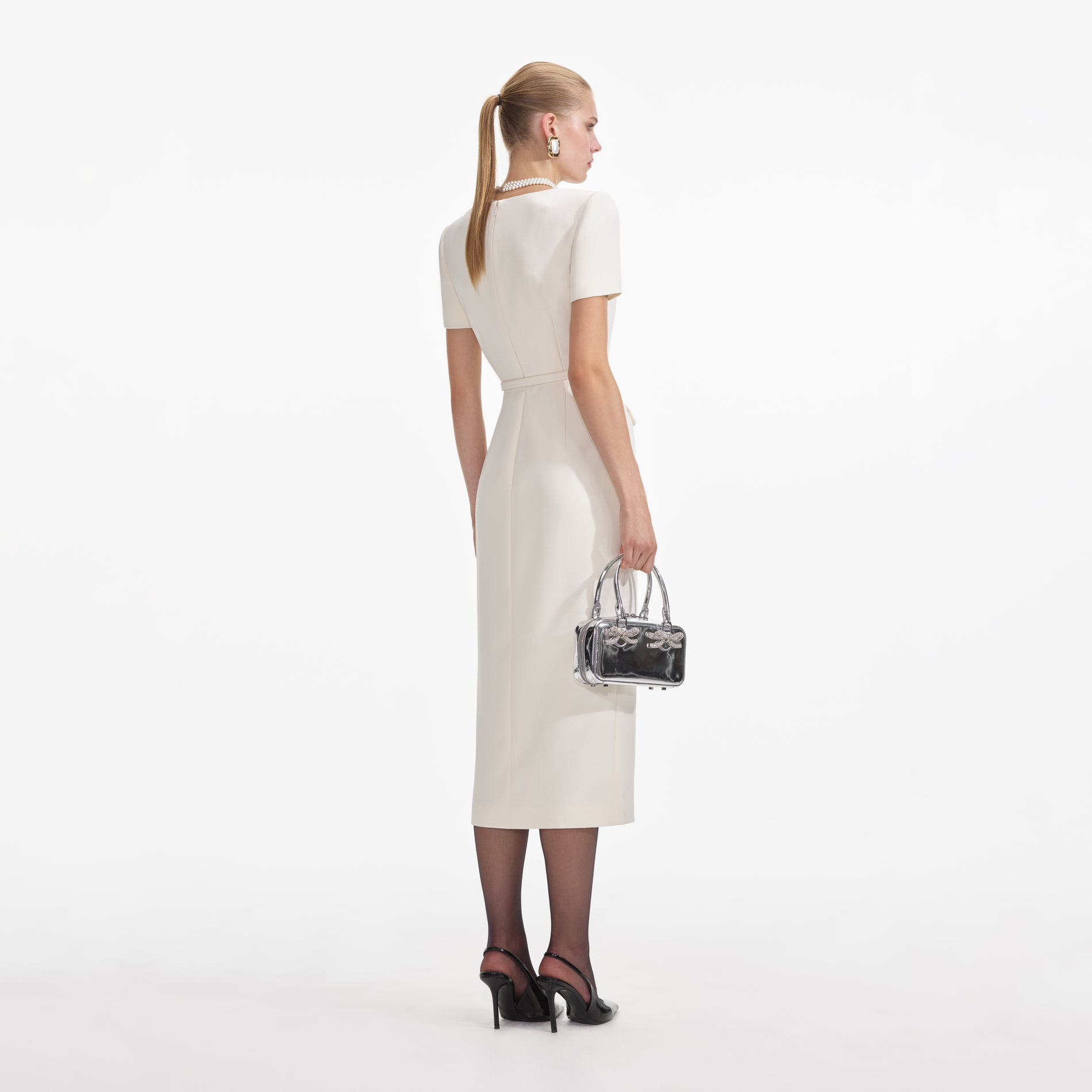 Back view of a woman wearing the Cream Crepe Button Midi Dress