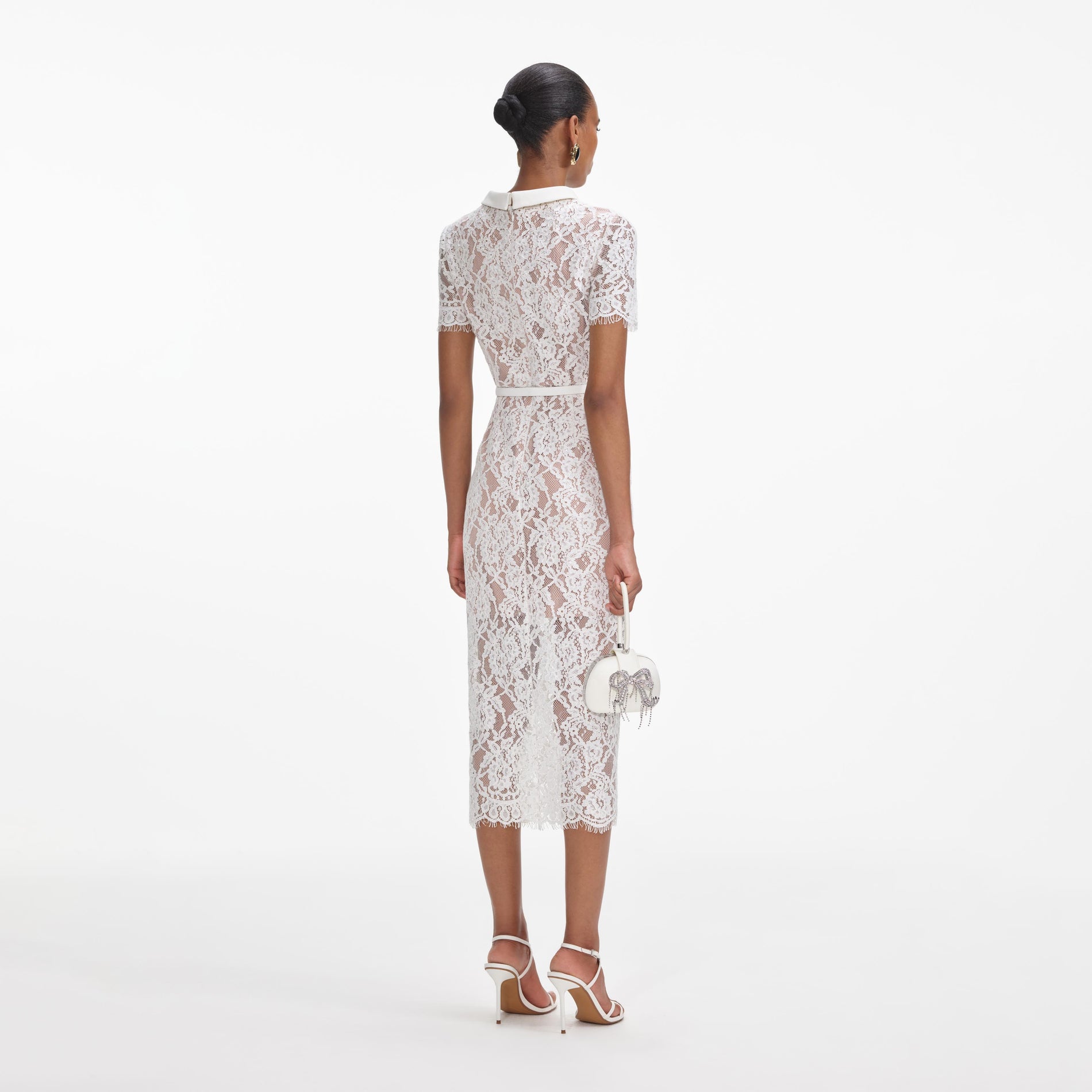 Back view of a woman wearing the White Lace Button Midi Dress