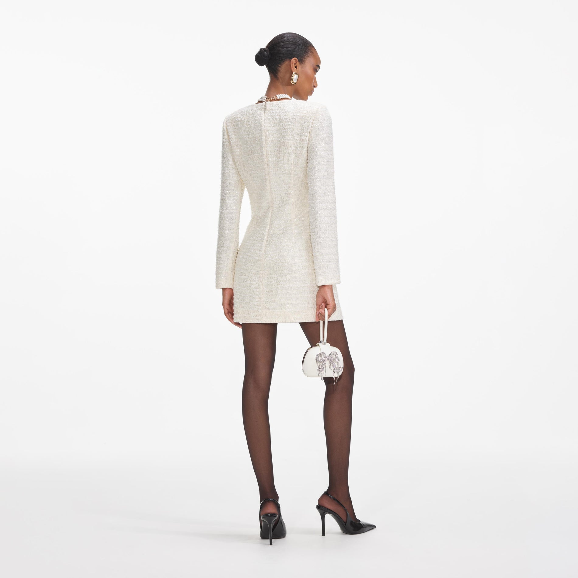 Back view of a woman wearing the Cream Boucle Diamante Bow Mini Dress