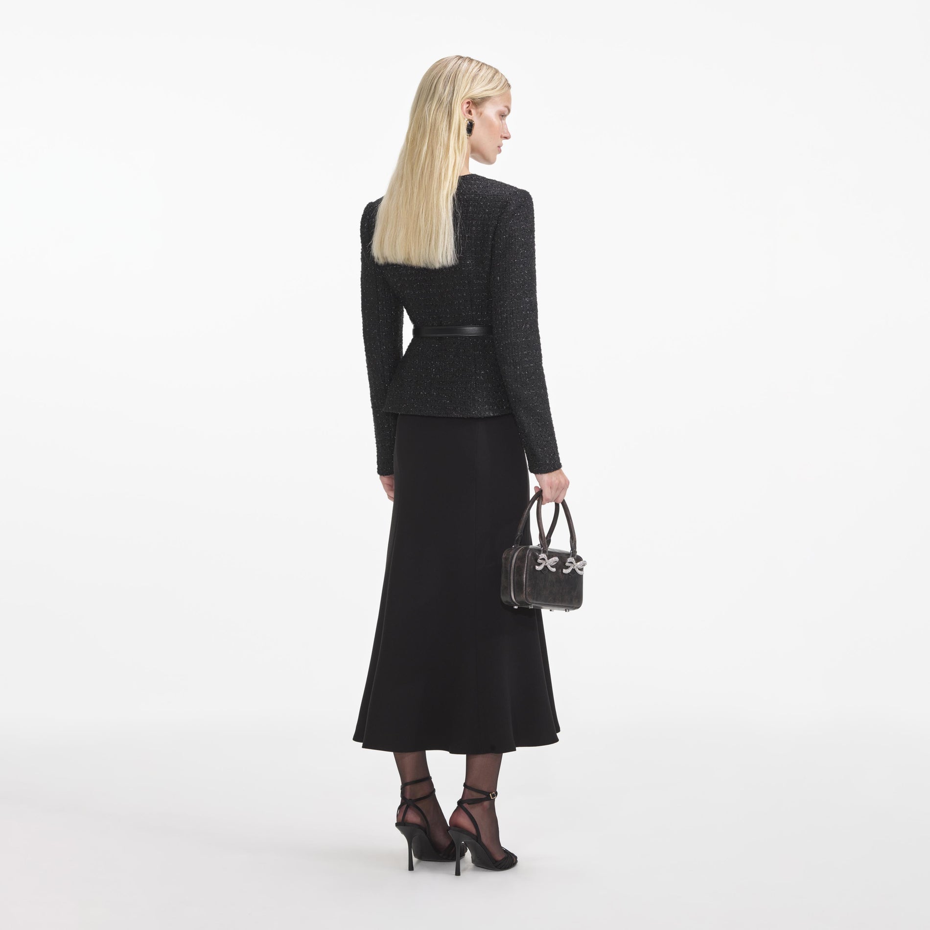 Back view of a woman wearing the Black Boucle Asymmetric Midi Dress