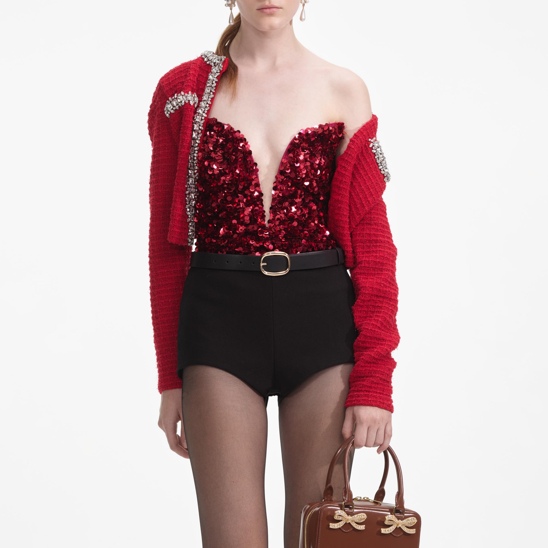 A close up of a woman wearing the Red 3D Sequin Top