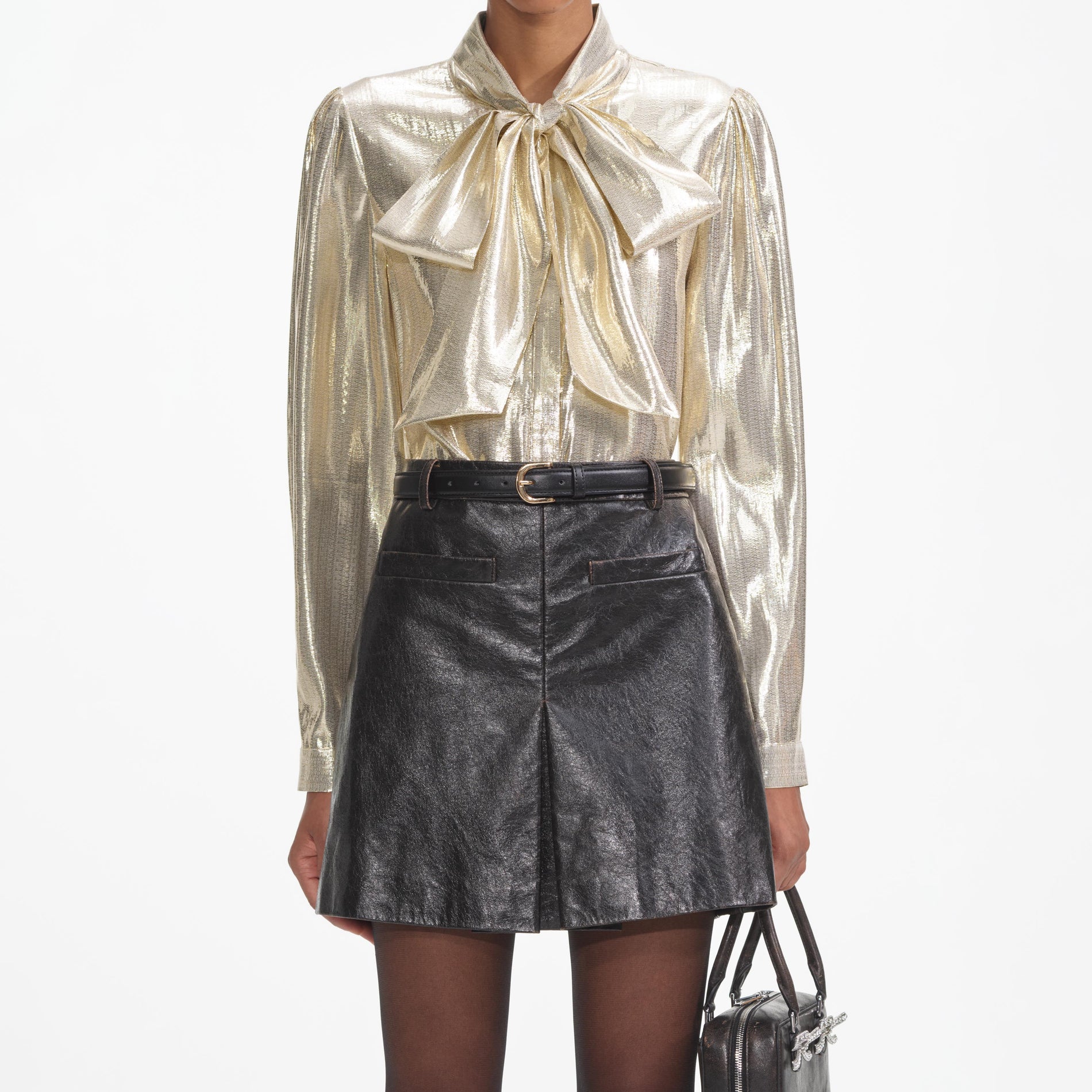 A close up of a woman wearing the Gold Metallic Pussy Bow Blouse