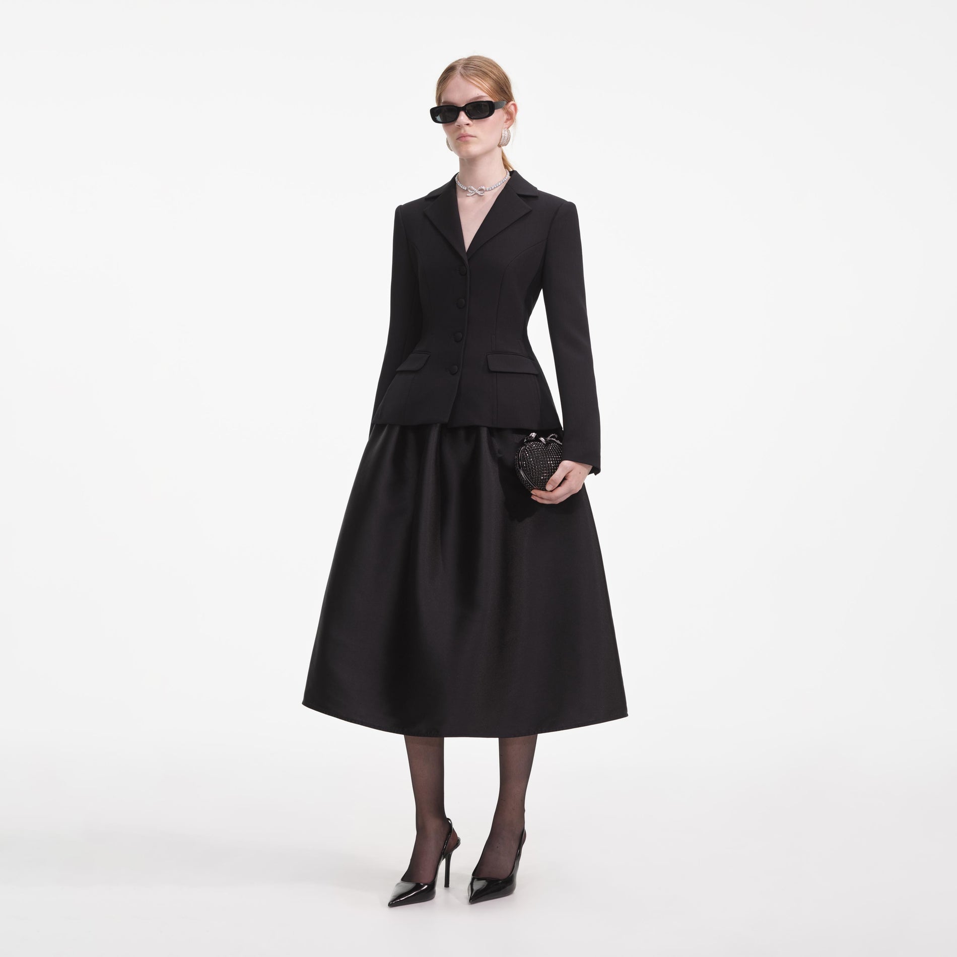Side view of a woman wearing the Black Tailored Midi Dress