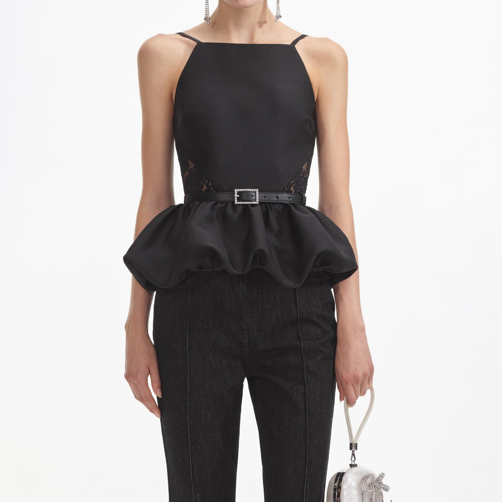 A close up of a woman wearing the Black Taffeta Peplum Top