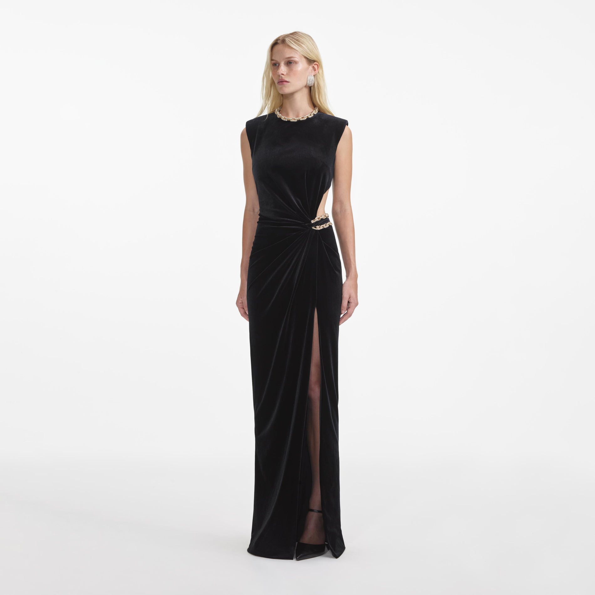 Side view of a woman wearing the Black Velvet Embellished Maxi Dress
