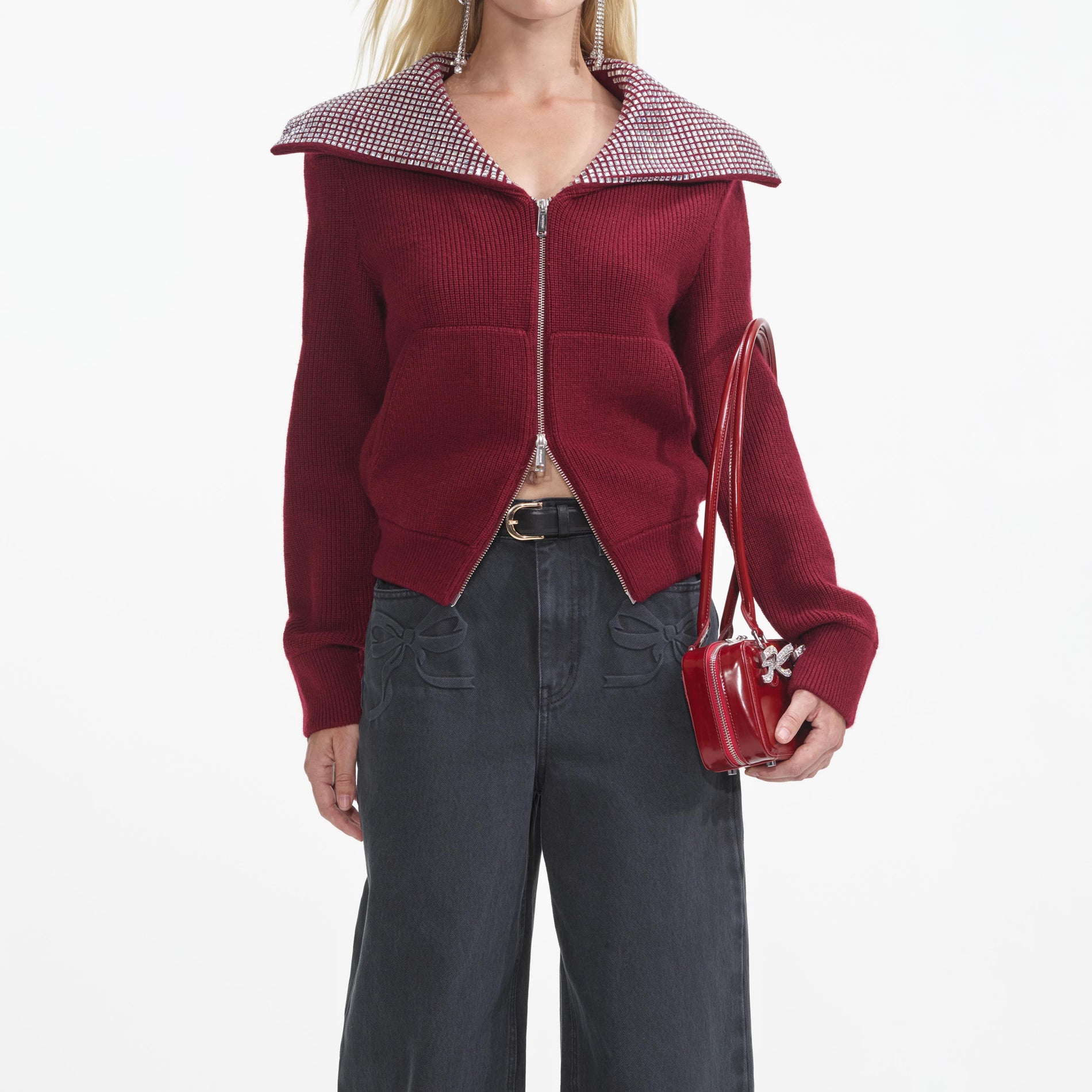 A close up of a woman wearing the Burgundy Diamante Collar Knit Jacket