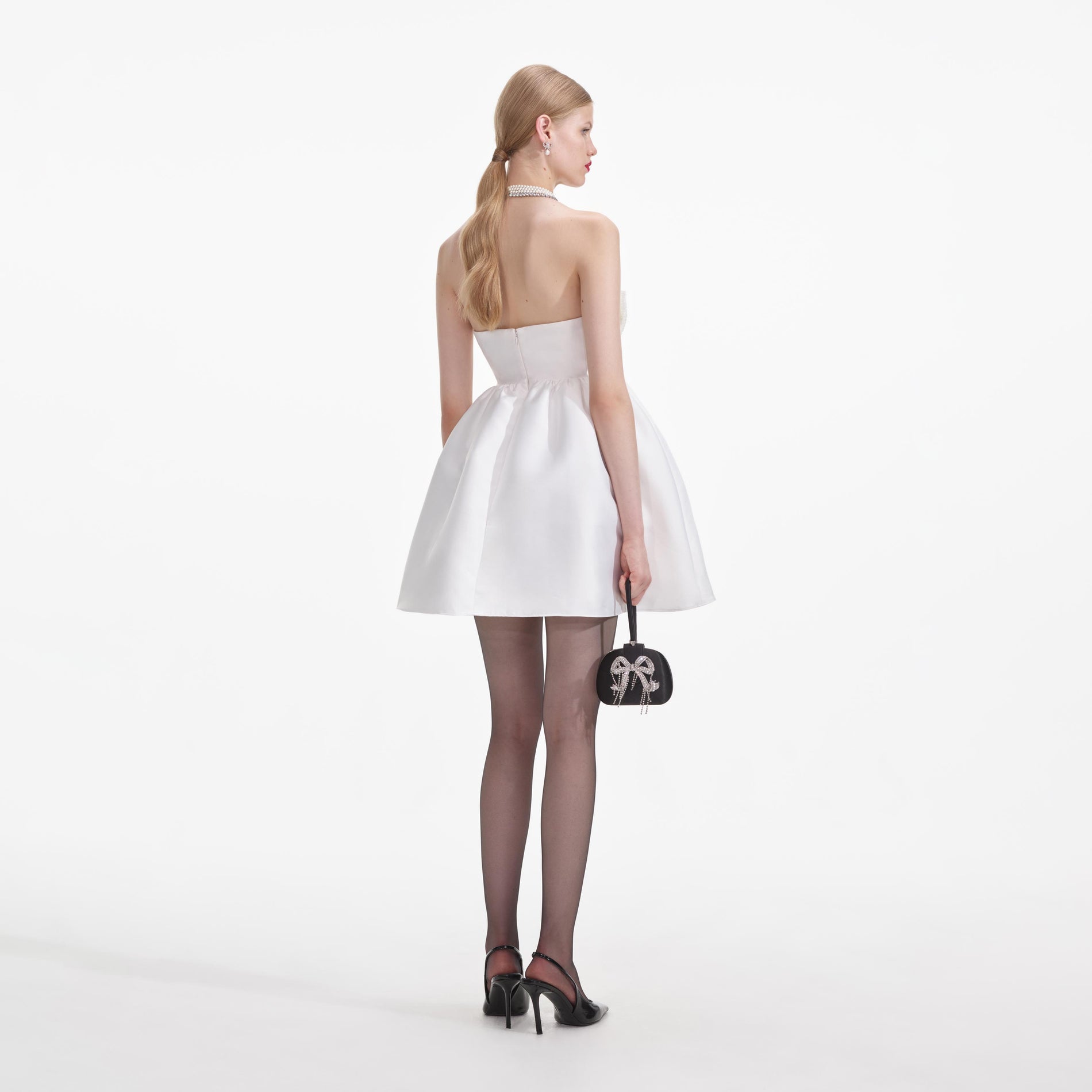 Back view of a woman wearing the White Taffeta Bandeau Mini Dress