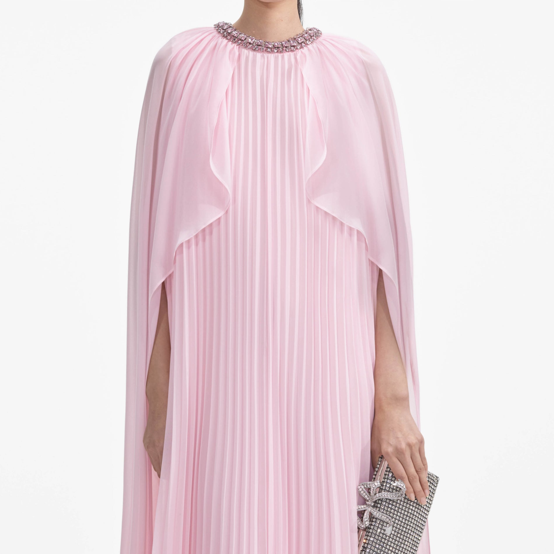 A close up of a woman wearing the Pink Chiffon Cape Midi Dress