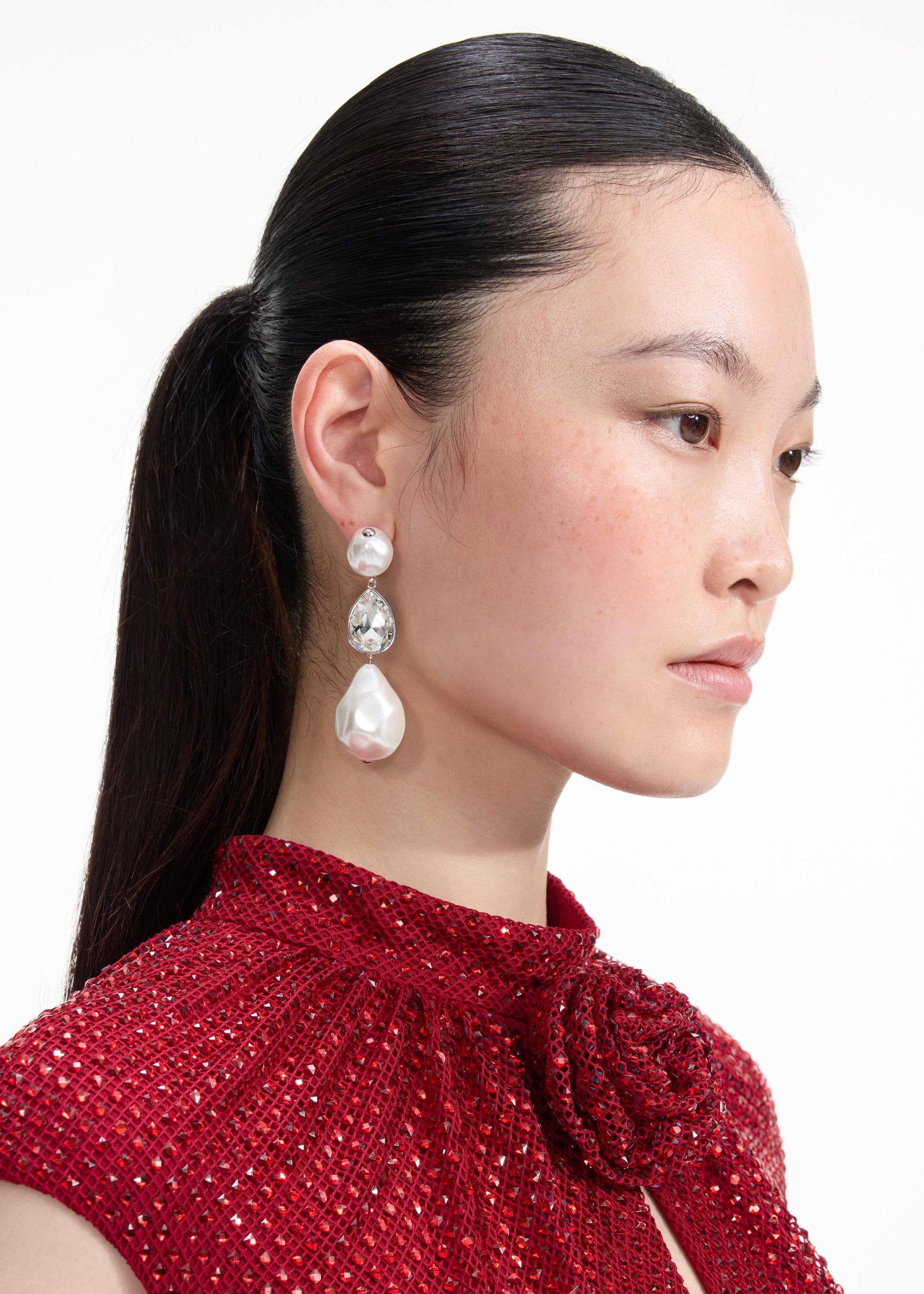 Back view of a woman wearing the Pearl Crystal Droplet Earrings