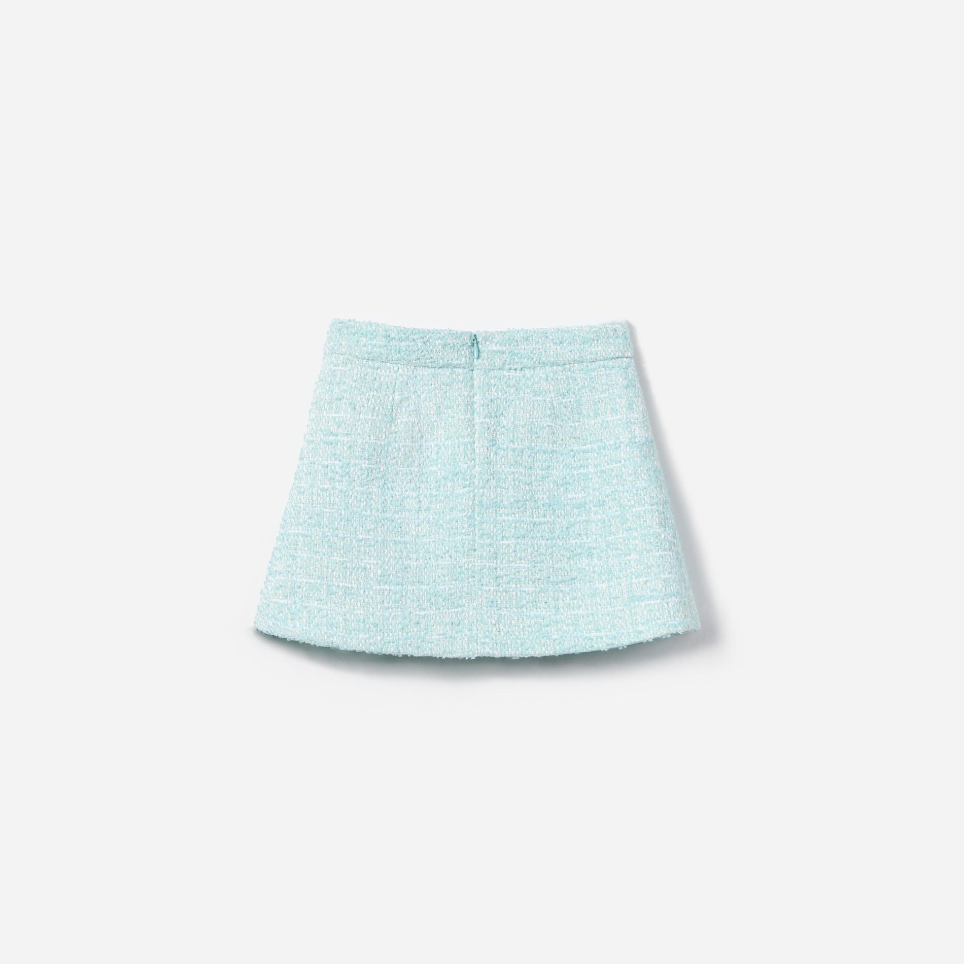 Side view of a woman wearing the Blue Boucle Skirt