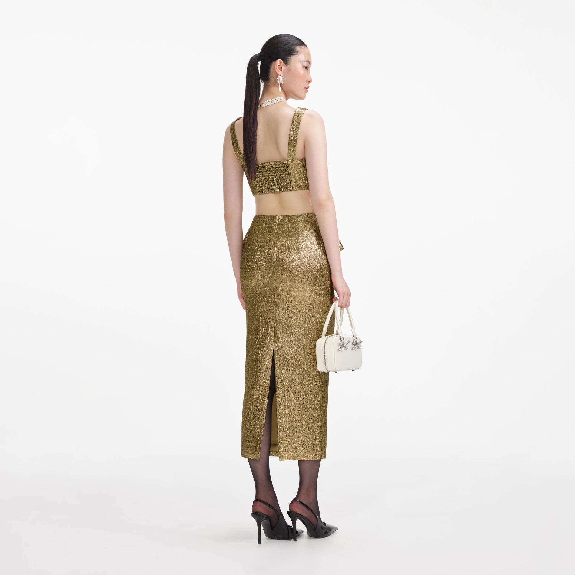 Back view of a woman wearing the Gold Metallic Jacquard Midi Skirt