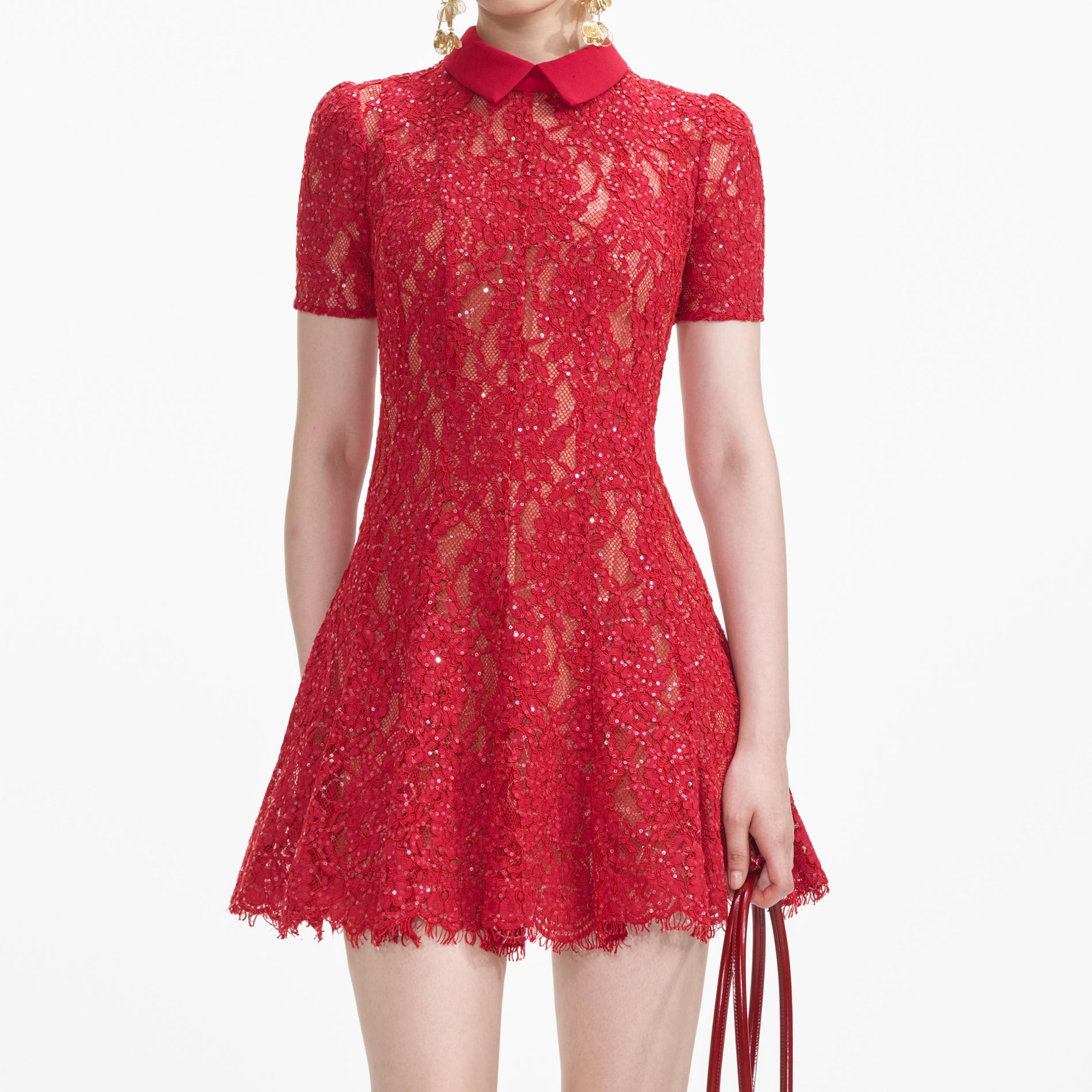 A close up of a woman wearing the Red Sequin Lace Mini Dress
