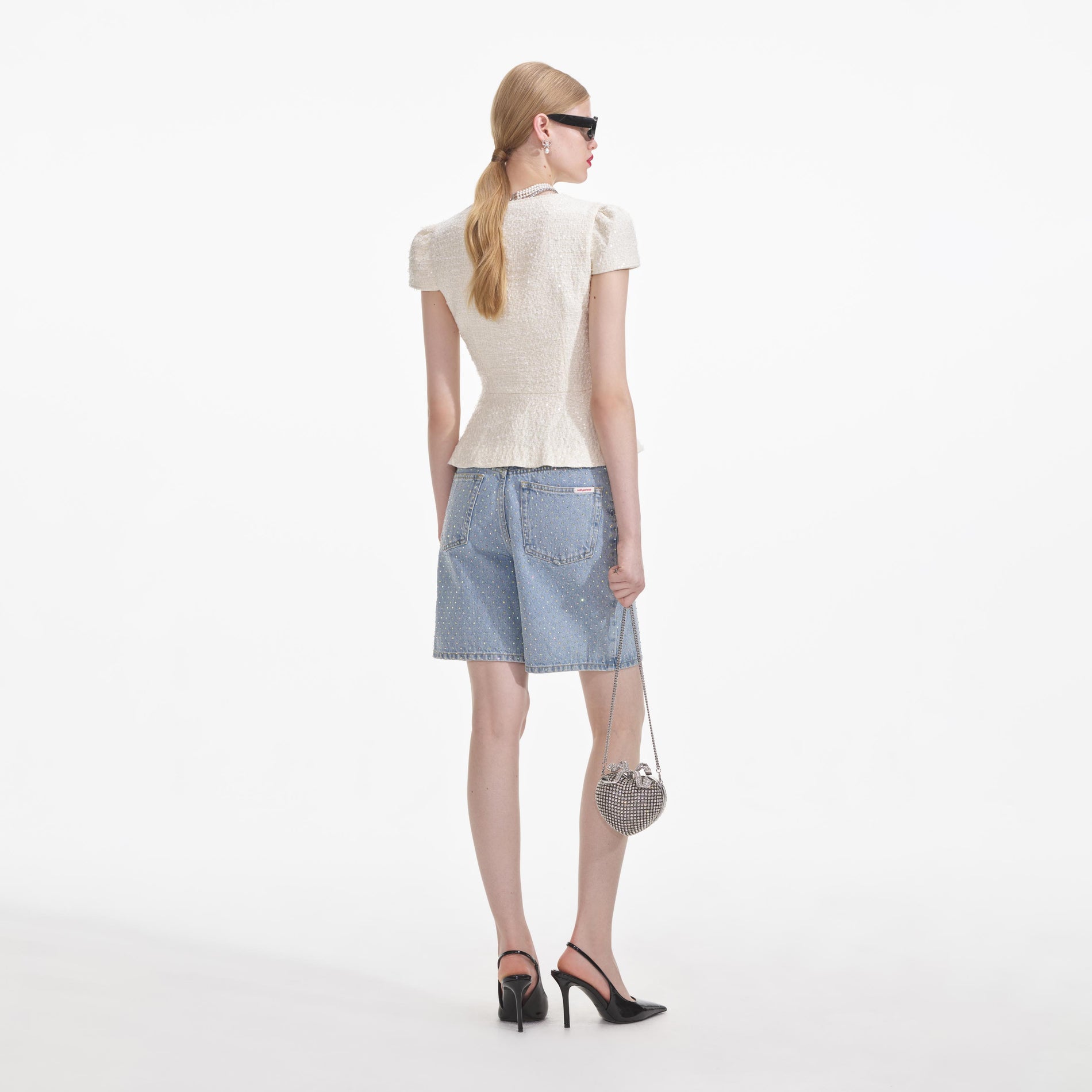 A close up of a woman wearing the Cream Boucle Bow Detail Top