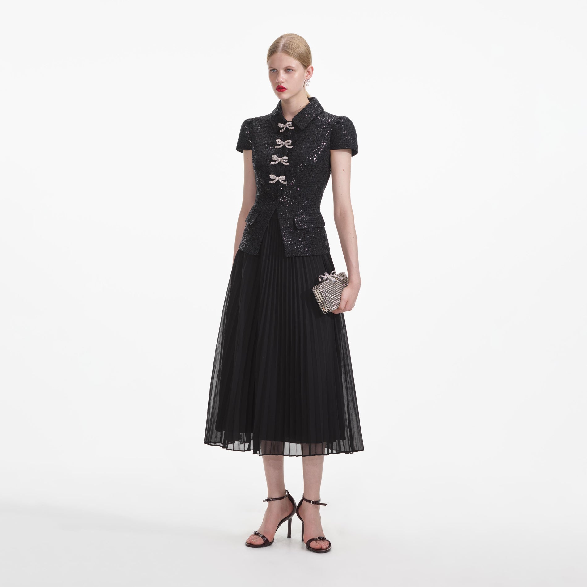 Side view of a woman wearing the Black Boucle Bow Midi Dress